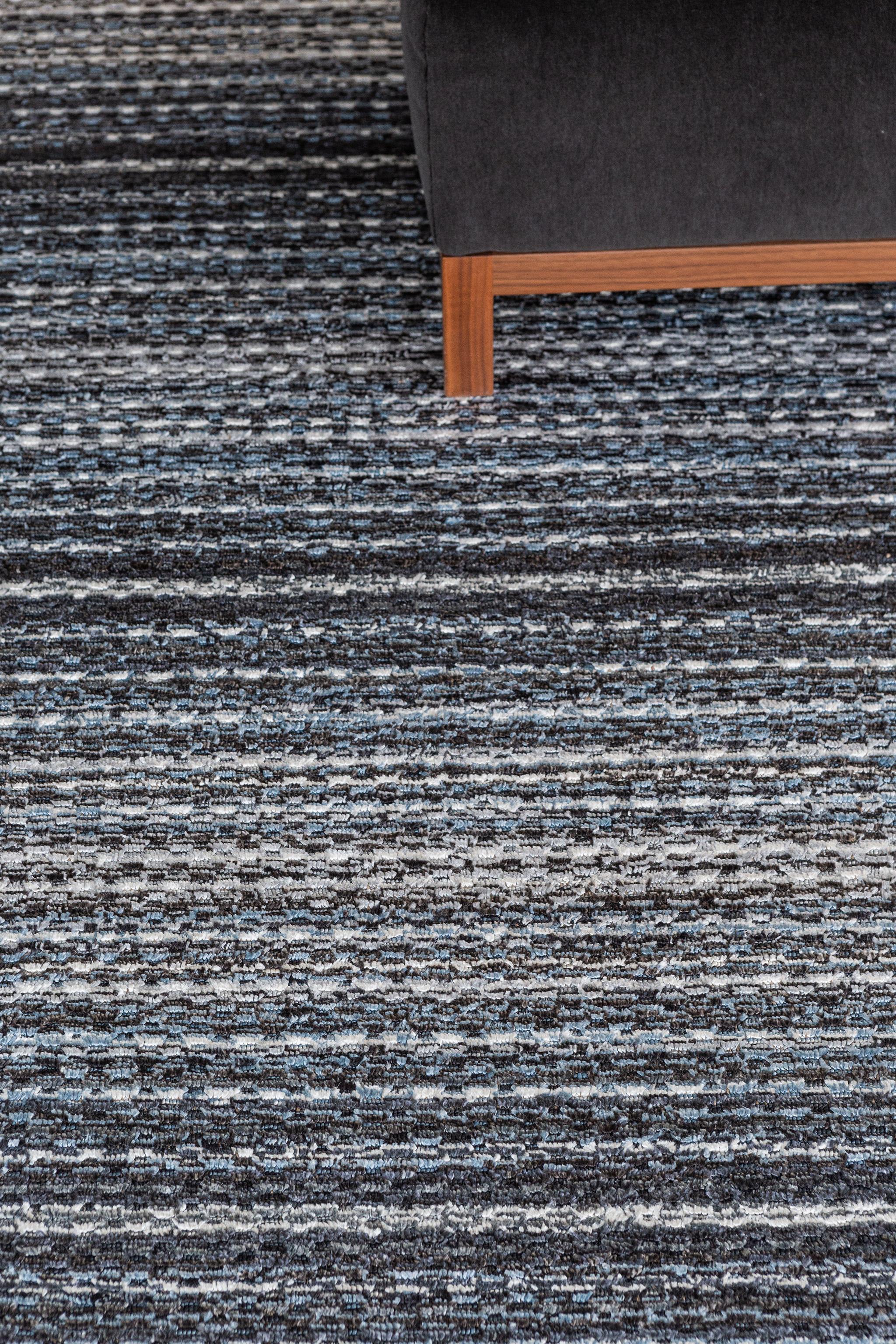 A fascinating modern hand loom rug in our Luca Collection. The delicate ribbed style rug in variegated tones of blue, charcoal and white give it a sophisticated and beguiling feel. Repeating pile detailing also brings a tranquil and noteworthy