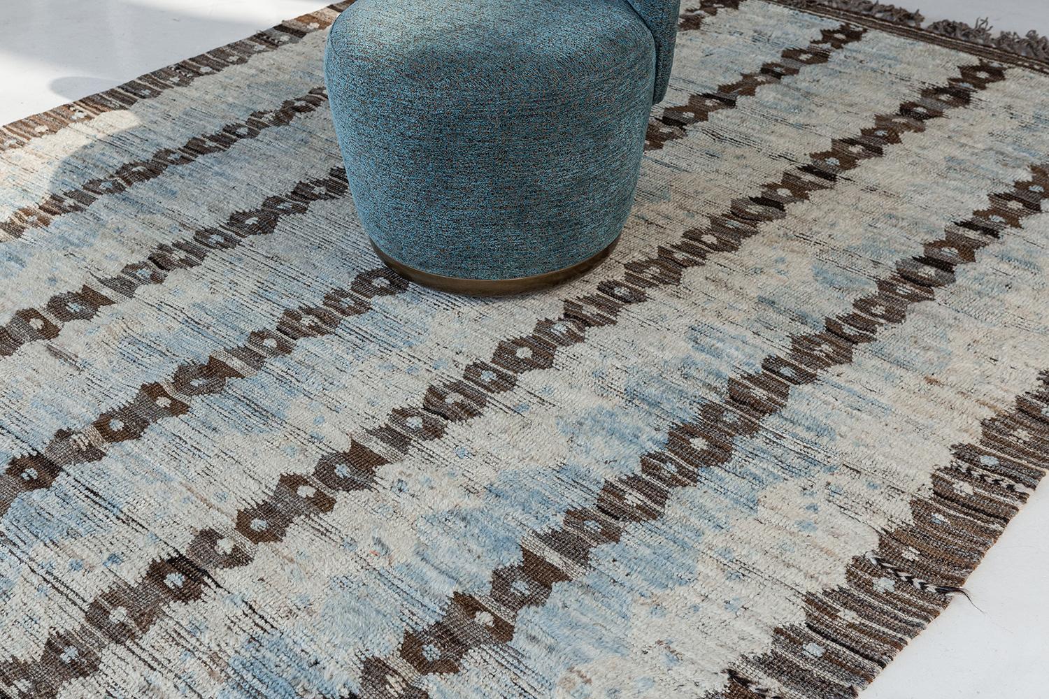 The 'Modlina' rug is a handwoven wool piece inspired by vintage Scandinavian design elements and recreated for the modern design world. The rug's shag balance and harmony, hand woven with a neutral flat weave and unique piles of peach and natural