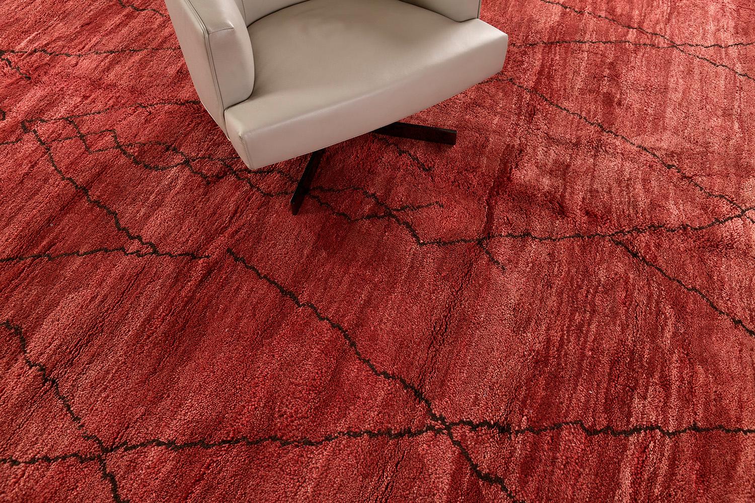 A remarkable tribal rug from our Middle Atlas Collection exhibits the symbolism including crisscross and diamonds. An interesting story narrated by the skillful weavers that are open to interpretation. Knotted in shades of vibrant red and brown. A