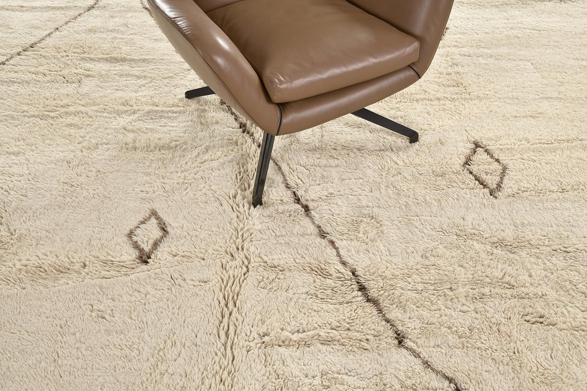 Be captivated by this luxurious carpet from Morroco. lt has a diamond pattern through the natural light brown rug and showcases the design in outlined-contrast which made it more unique. Sink your feet into a Middle Atlas Tribe kind of rug that will