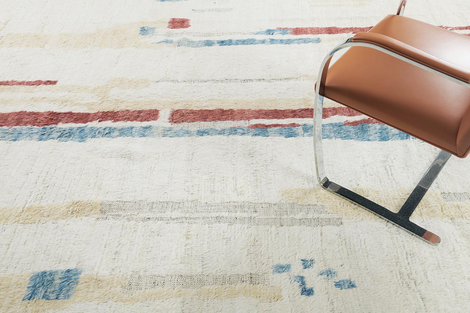 Nakhla' displays vivid colour scheme and a modern interpretation of the Moroccan world. This rug’s irregular crimson, aquamarine and cream strokes resembles the fibers of nature and their ability to be used for crafts such as cords and basketry.