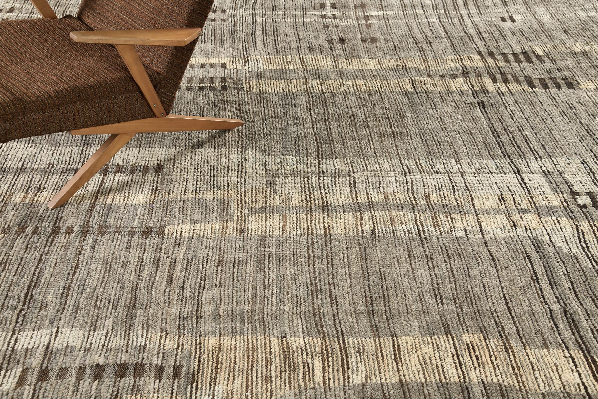 Nakhla' is a natural earth toned rug and a modern interpretation of the Moroccan world. This rugs irregular taupe, umber brown, tortilla and taupe strokes resemble the fibers of nature and their ability to be used for crafts such as cords and