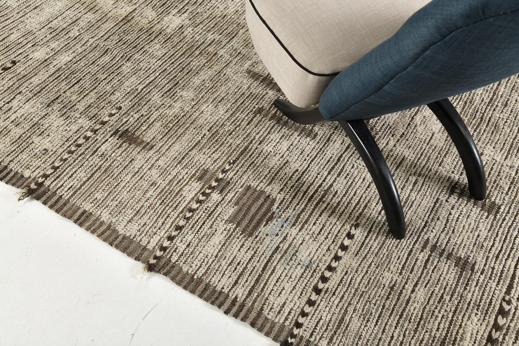 Nakhla is a natural earth-toned rug and a modern interpretation of the Moroccan world. These rugs' irregular patches of cream, blue, and gray resemble the fibers of nature and their ability to be used for crafts such as cords and basketry. Designed