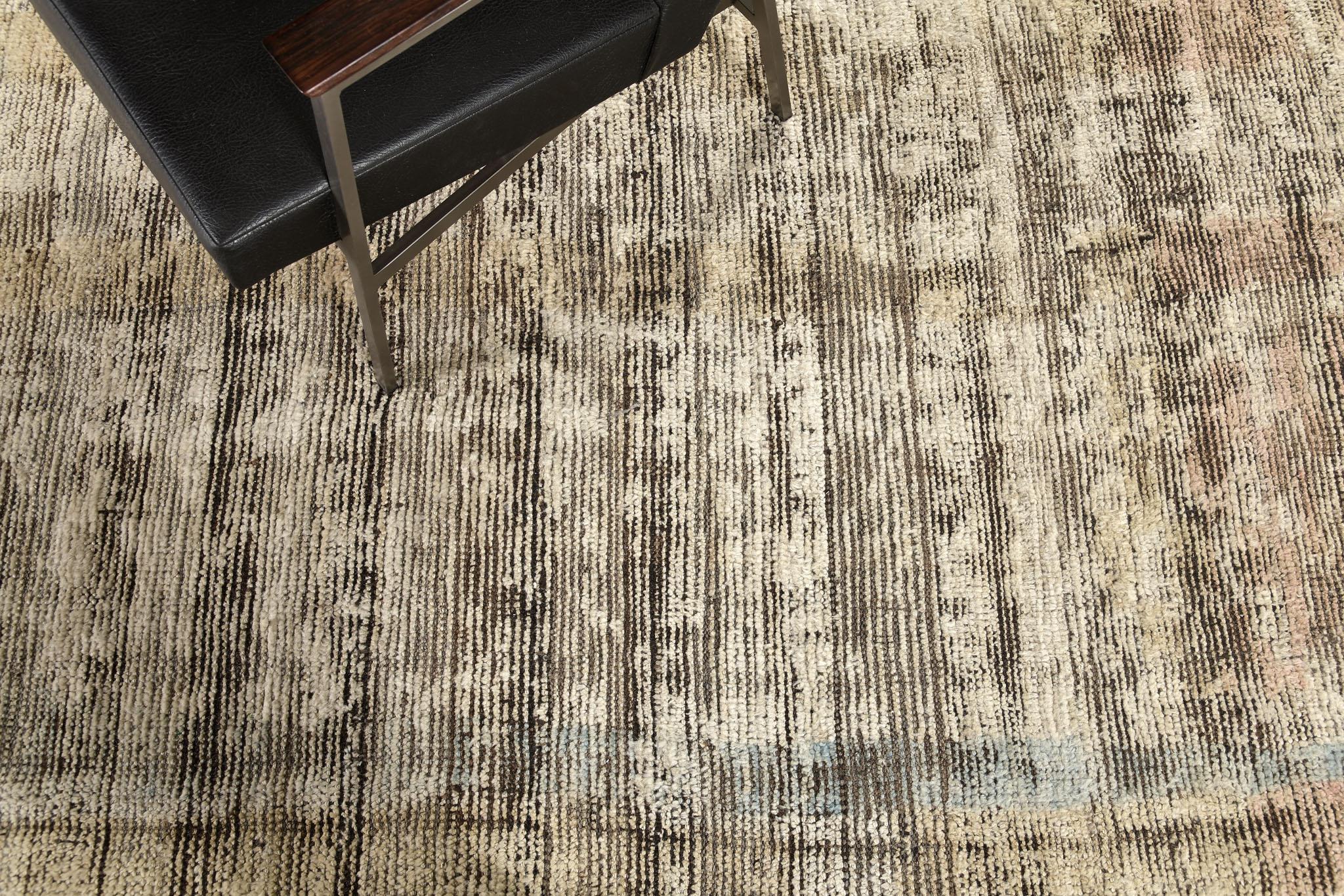 Nakhla is a natural earth-toned rug and a modern interpretation of the Moroccan world. These rugs' linear strokes of cream, blue, and gold resemble the fibers of nature and their ability to be used for crafts such as cords and basketry. Designed in