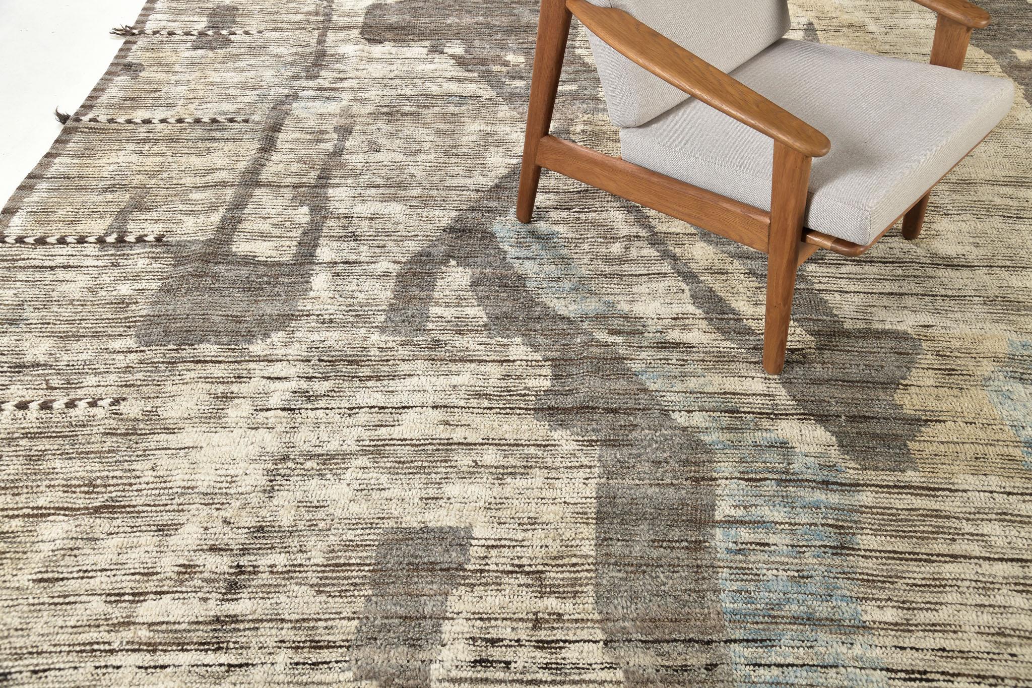 Nakhla is a natural earth-toned rug and a modern interpretation of the Moroccan world. These rugs' irregular patches and linear strokes of cream, blue, and gray resemble the fibers of nature and their ability to be used for crafts such as cords and