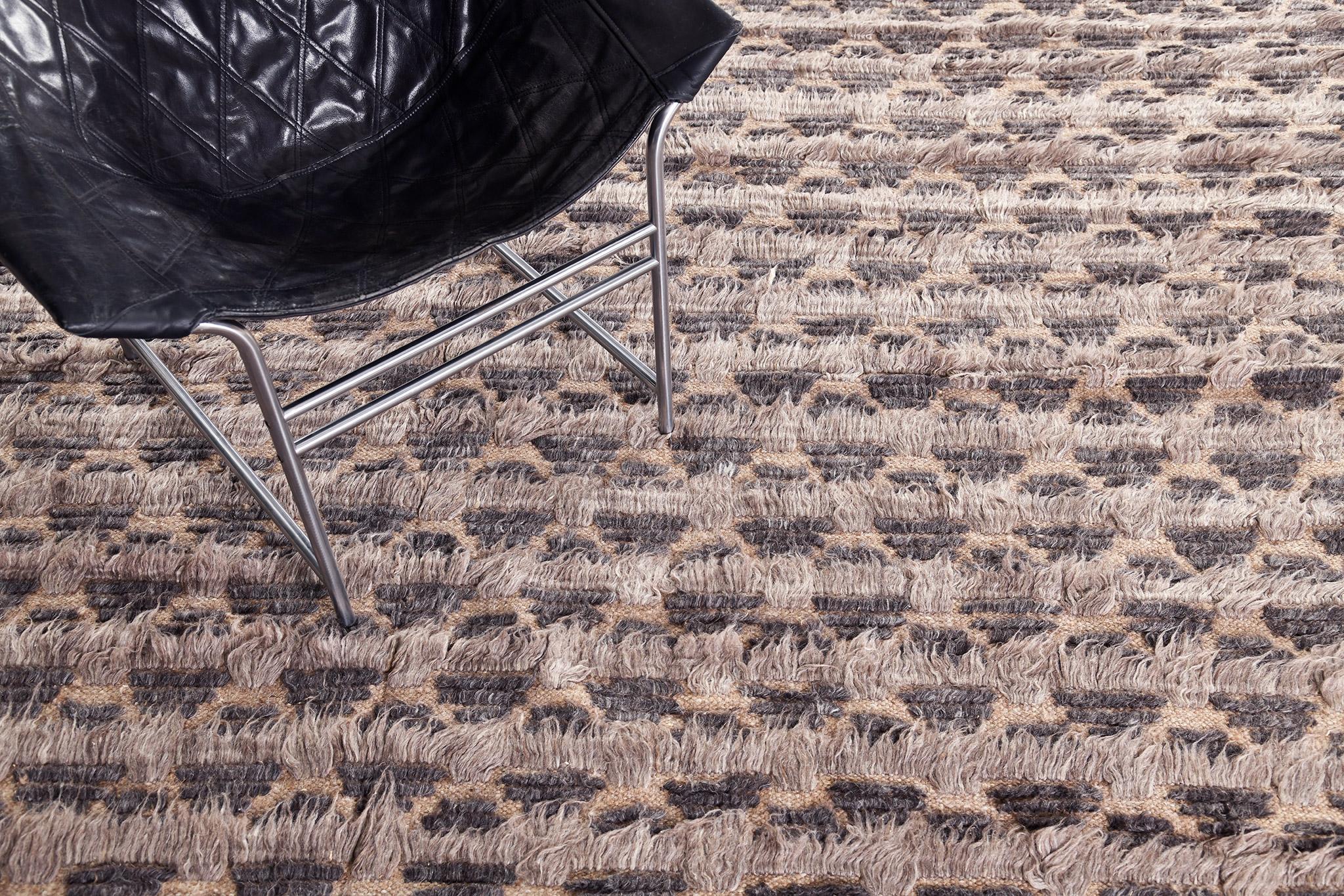 In the Nami rug, varied pile heights and flatweave design elements are configured in a petal lattice motif of deep browns with soft cocoa lineation.

An extension of Mehraban’s popular Amihan design, the Sahara Collection delves further with