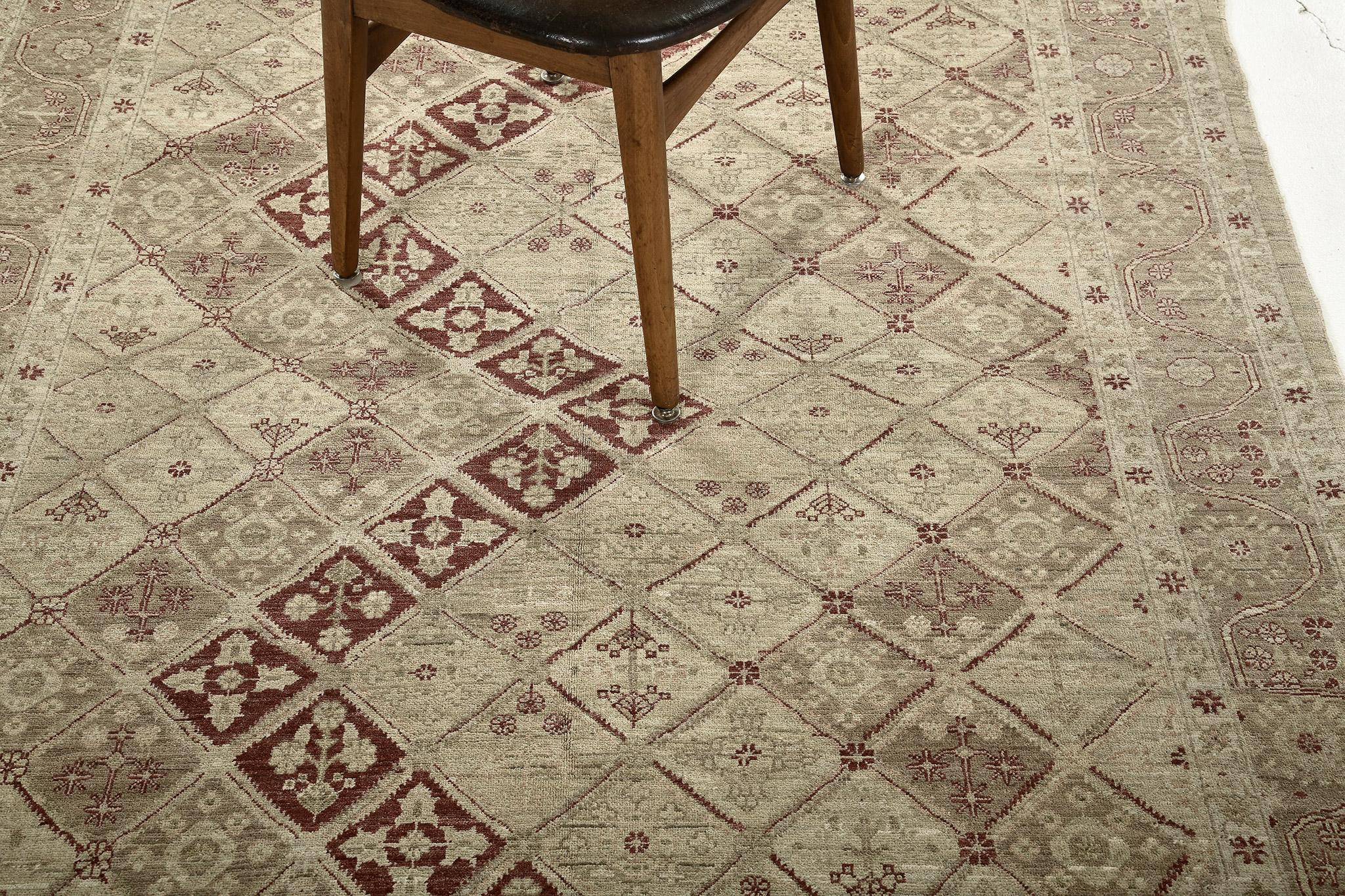 A sophisticated Classic Panel Design in Fable Collection revival rug that is impeccably woven with various botanical elements in the soothing muted combinations of ivory, sand, taupe and ruby red accent. This refined rug charms with ease and