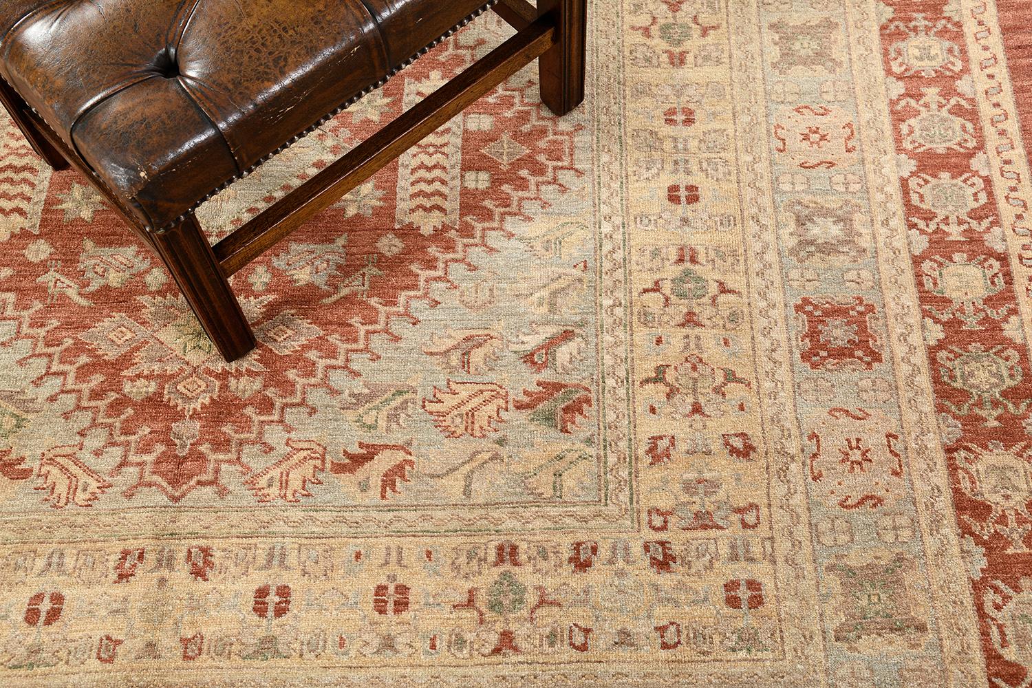 A stylishly luxurious hand-spun wool Gashgai Style Rug has immensely flexed its series of the band along the perimeter of emblems. It is surrounded by different kinds of intricate symbols and geometric motifs. The neutral color scheme with the red