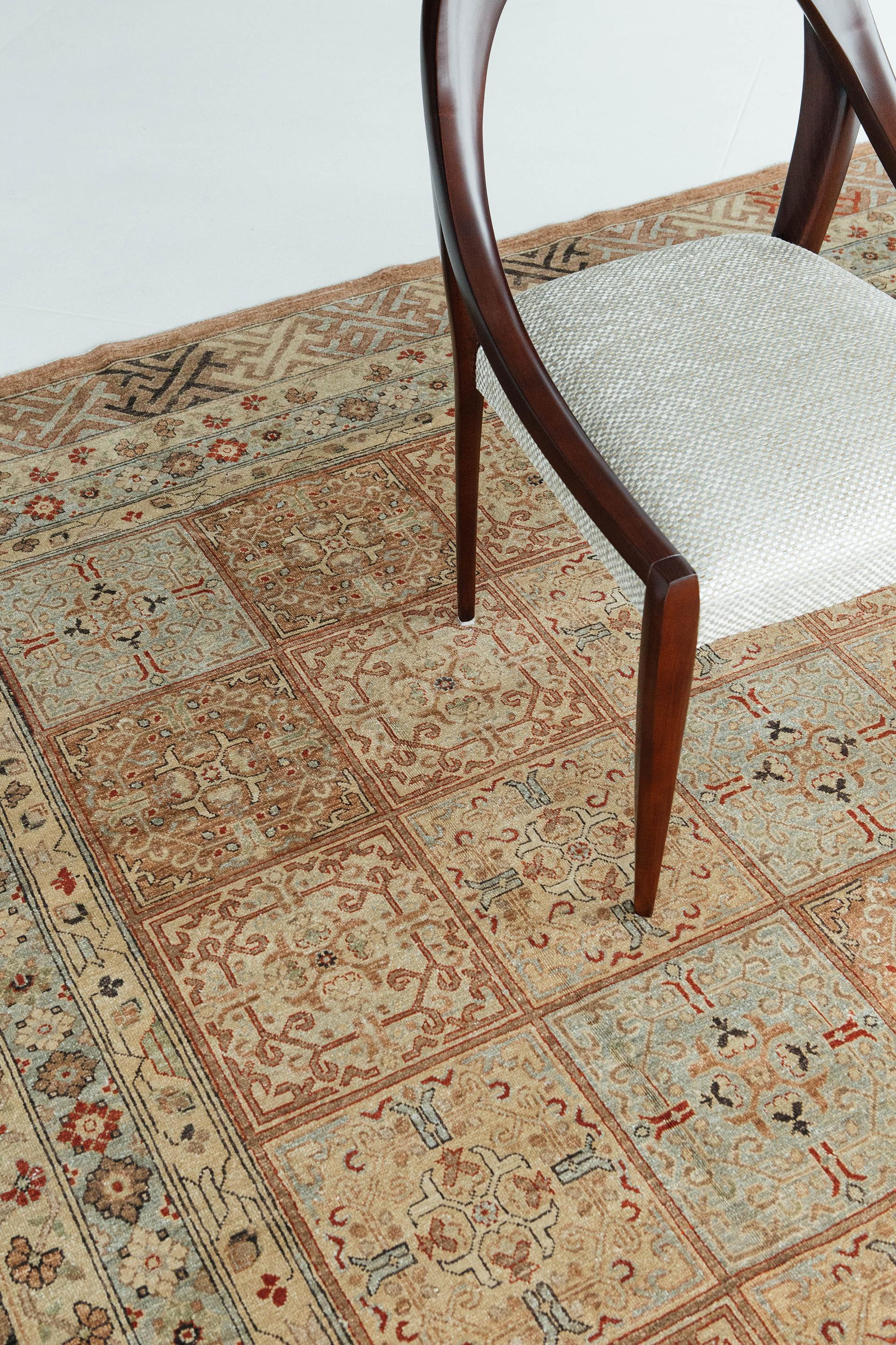 Featuring formal garden blocks and paths decorated with floral motifs, this charming antique Khotan carpet is a true work of art. The natural dyed wool colors work cohesively and create a elegant and cohesive look that will elevate any room.

Rug