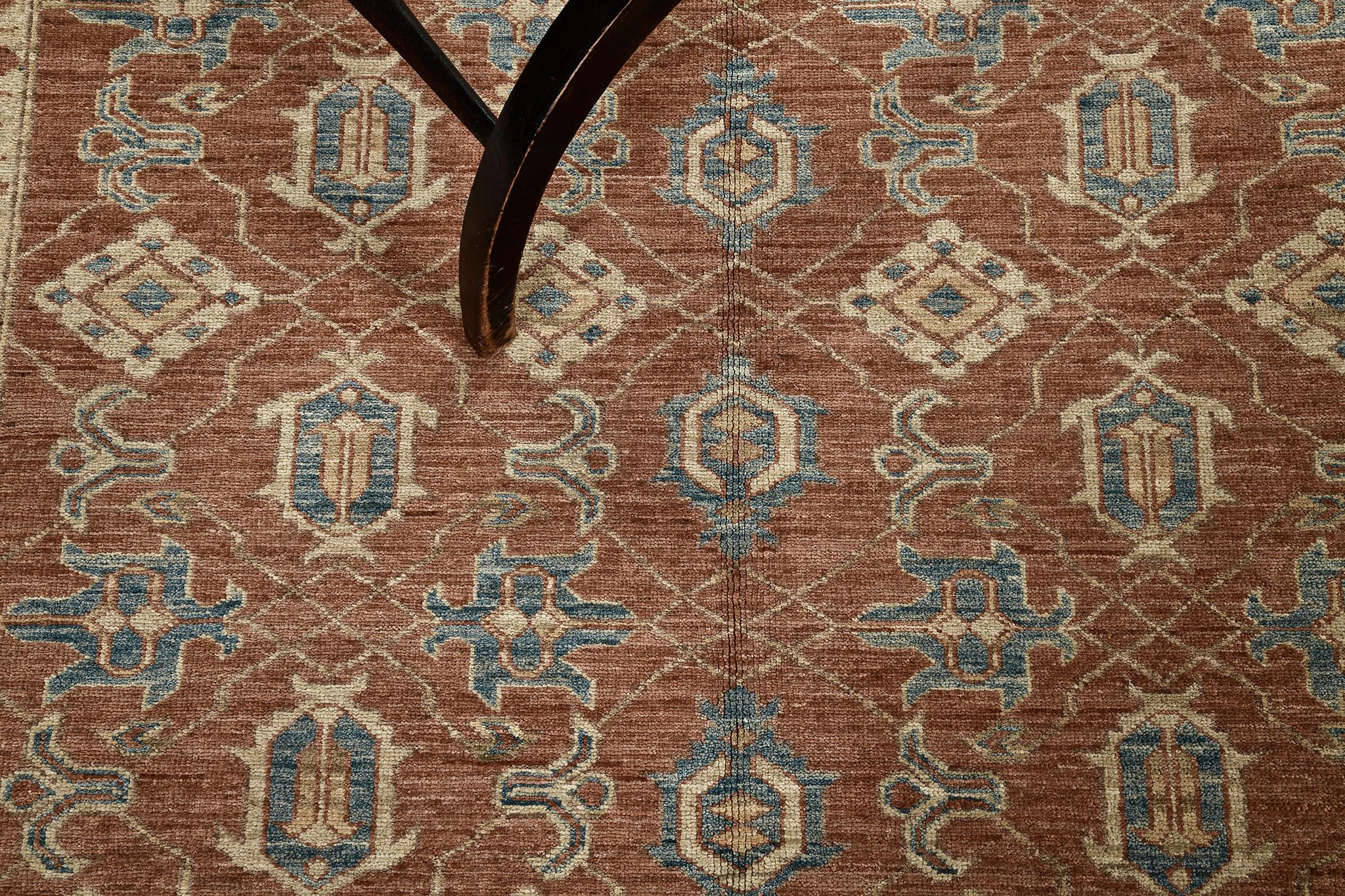 A phenomenal Mamluk revival that features the vivid tones of terracotta and cerulean blue that gives a space a contemporary feel. Featuring the all-over geometric field and borders, this enticing rug reflects the impressive attention to details.