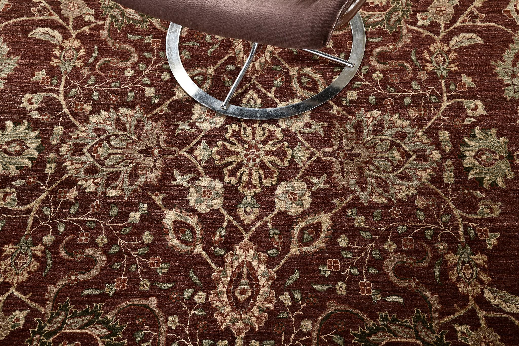 A vibrant Sarouk Farahan Style rug that beguiles you to an all-over pattern of botanical elements that are poised to impress. The abrashed ruby field is covered by majestic patterns of blooming palmettes, alluring blossoms, symmetrical lilies,