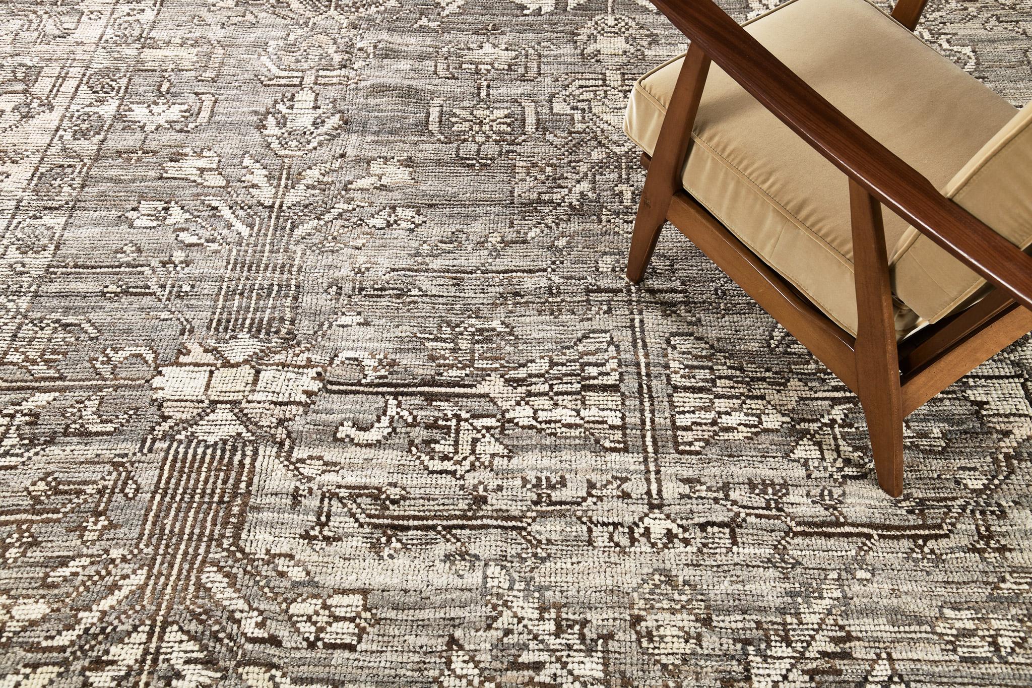 Featuring an all over dainty botanical motifs of this Oushak revival rug, displays the most sought after colour palette of taupe and ecru. Blooming palmettes are gracefully displayed all throughout the field and borders of this mesmerizing piece.