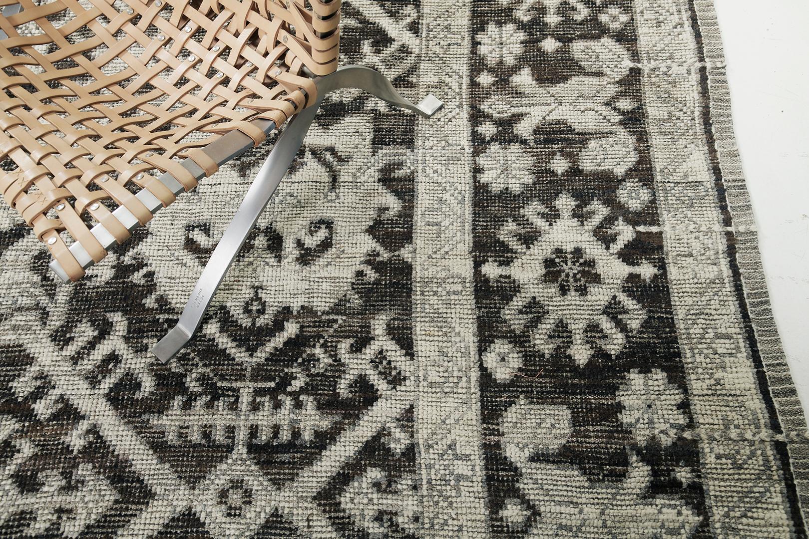 A captivating Oushak revival rug that is a magnificent translation of bold sophistication. Distinctive palmettes, and florid patterns are showcasing remarkable elegance in the stunning shades of charcoal and ecru enclosed by a fascinating