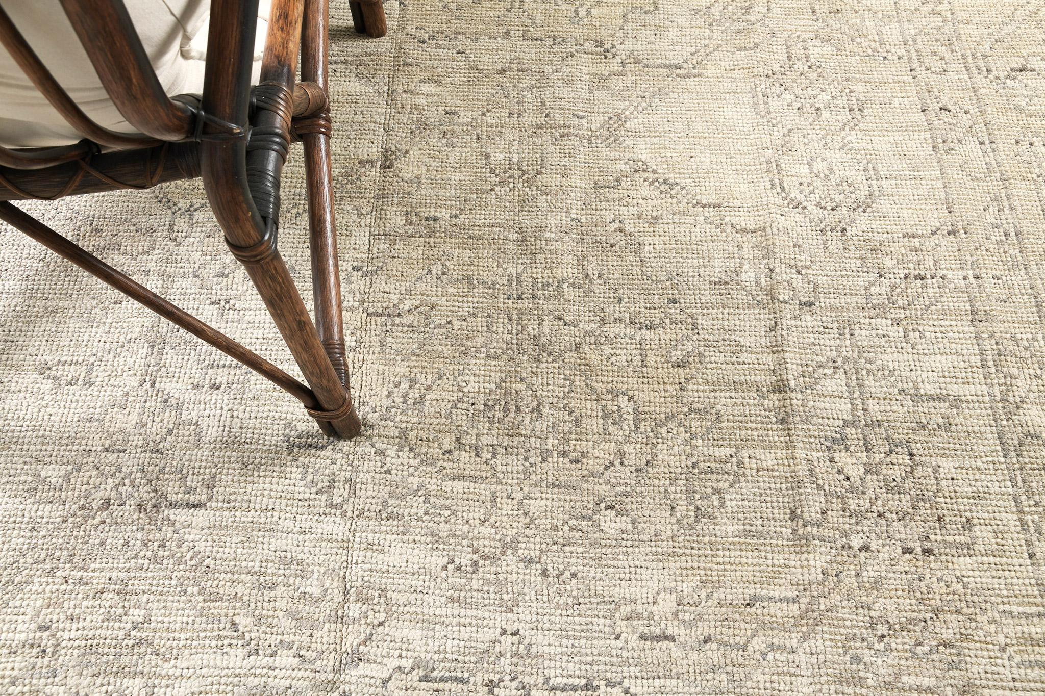 A phenomenal Oushak design revival rug that has an intricate and timeless pattern. Featuring the collaboration of muted tones of taupe and charcoal , this bewildering rug is composed with enchanting graceful iris and florid elements that create a