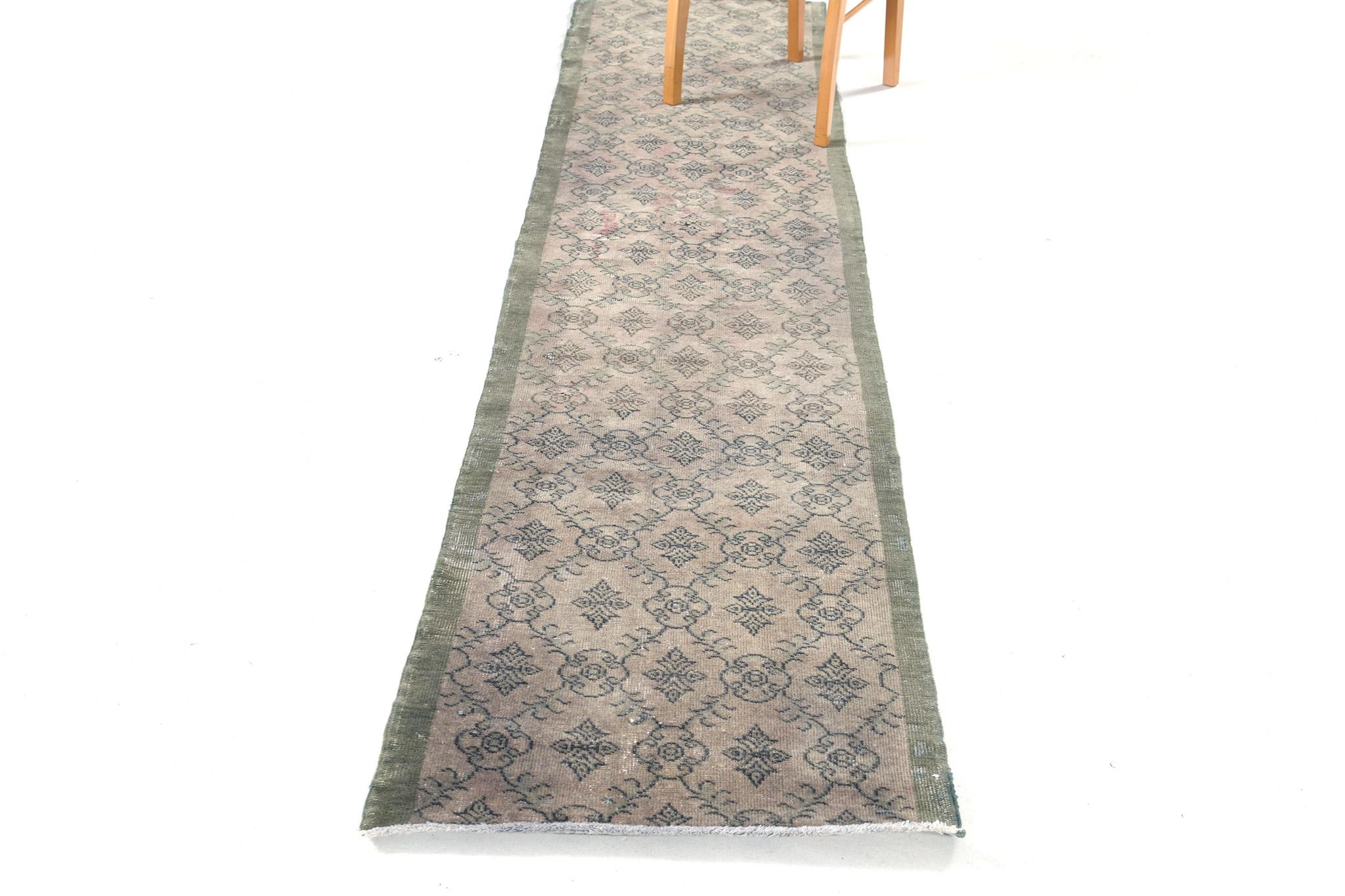 The effervescent sophistication and rustic colour scheme bring elegance to this Vintage Turkish Anatolian runner. It embodies an allover interconnected botanical pattern that features the series of florid lozenge trellis gracefully spread over this