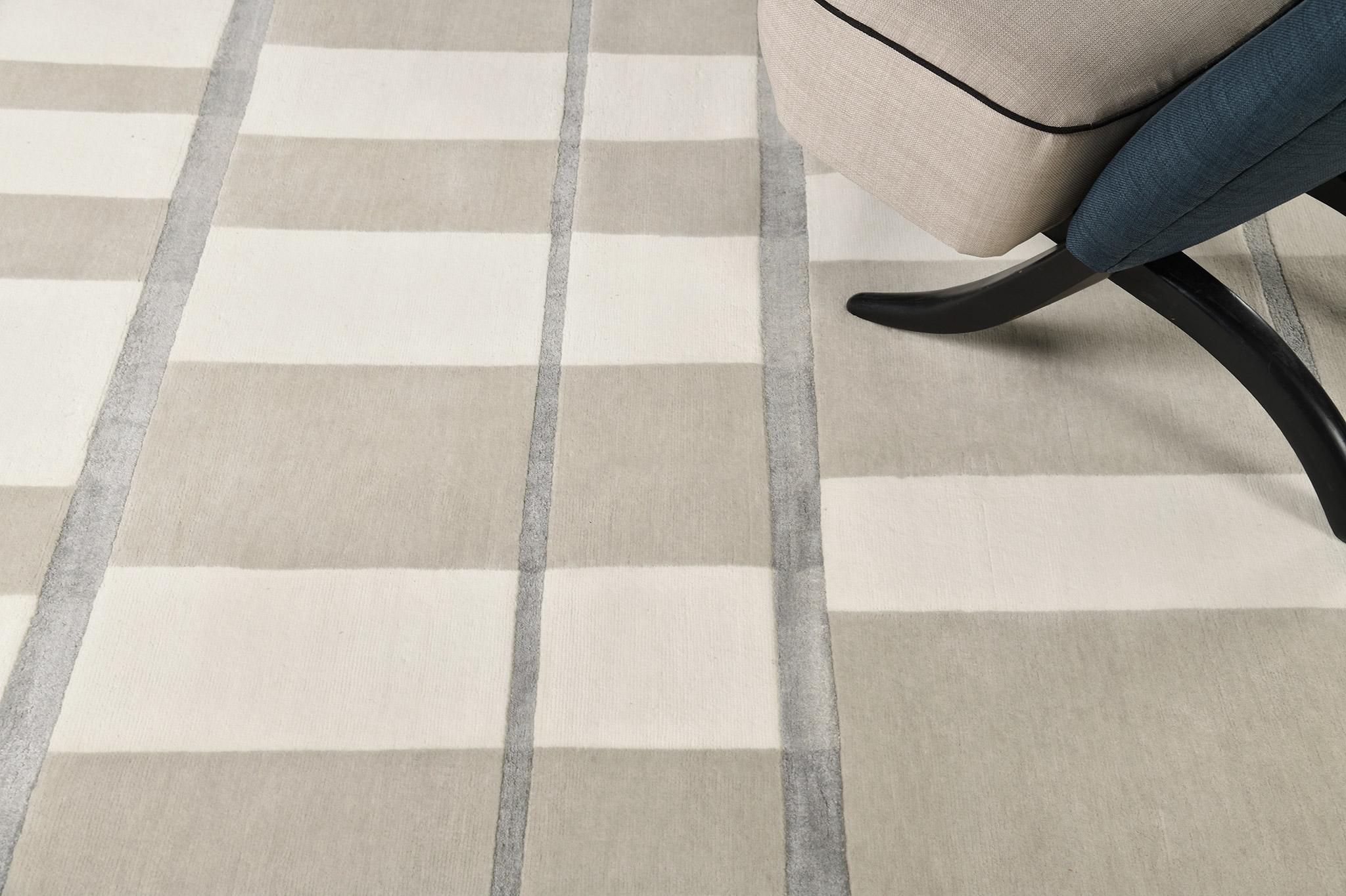 Pazienza expresses its simplicity and charm to add beauty to your interior. Alternates of gray and ivory with some sage blue lines show how stunning it will be. A rug like this will complement every interior and much appreciated by your