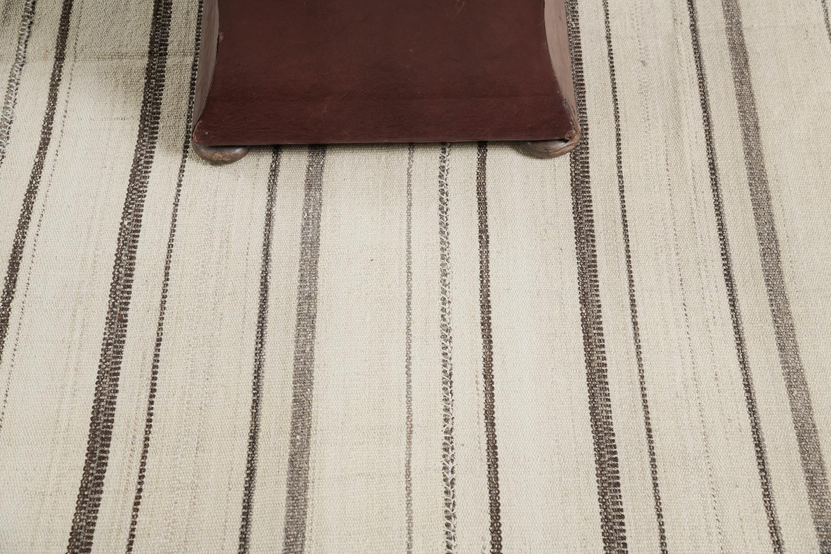 This Persian Jejim Kilim is a banded flat weave with alternating hues of cream, khaki, and clay brown in multi-column stripes. Persian flatweaves are made up of some of the best wool and weaved exceptionally to create interesting textures. This