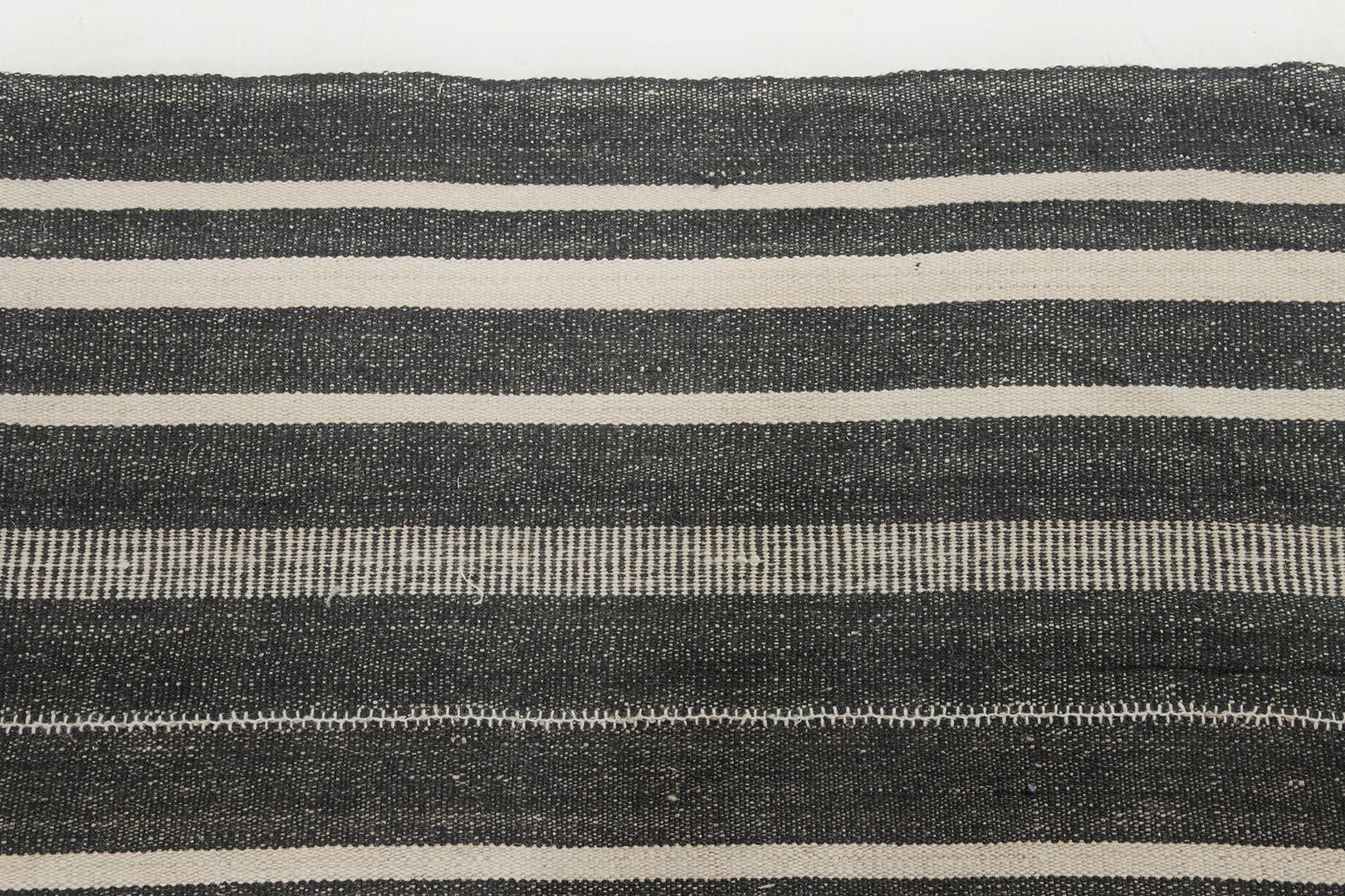 This Persian Jejim Kilim features a flat weave with a versatile pattern of multi-width stripes of black and cream. It is perfectly suited for modern contemporary interiors. These graphic stripes on the rug would be equally at home in a western