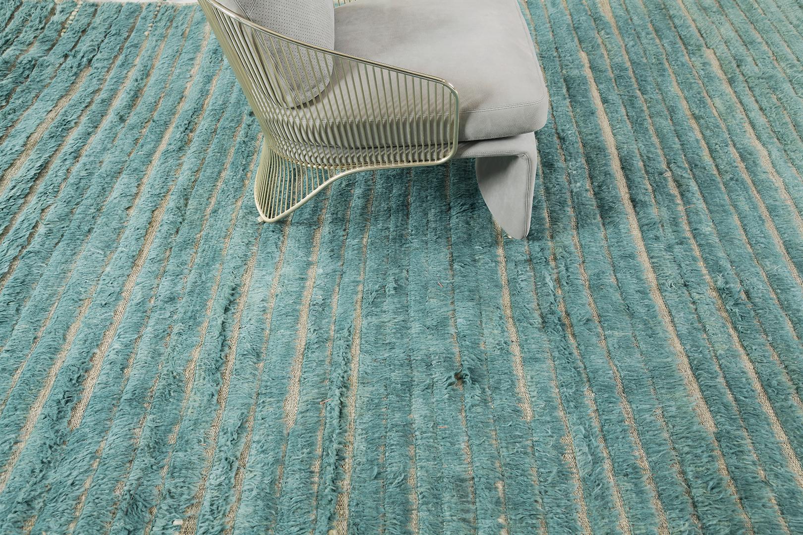 Shipca is a handwoven luxurious wool rug with timeless embossed detailing. In addition to its vibrant turquoise flat weave, Shipca has a beautiful shag that brings a lustrous and contemporary feel to one's space. The Haute Bohemian collection is