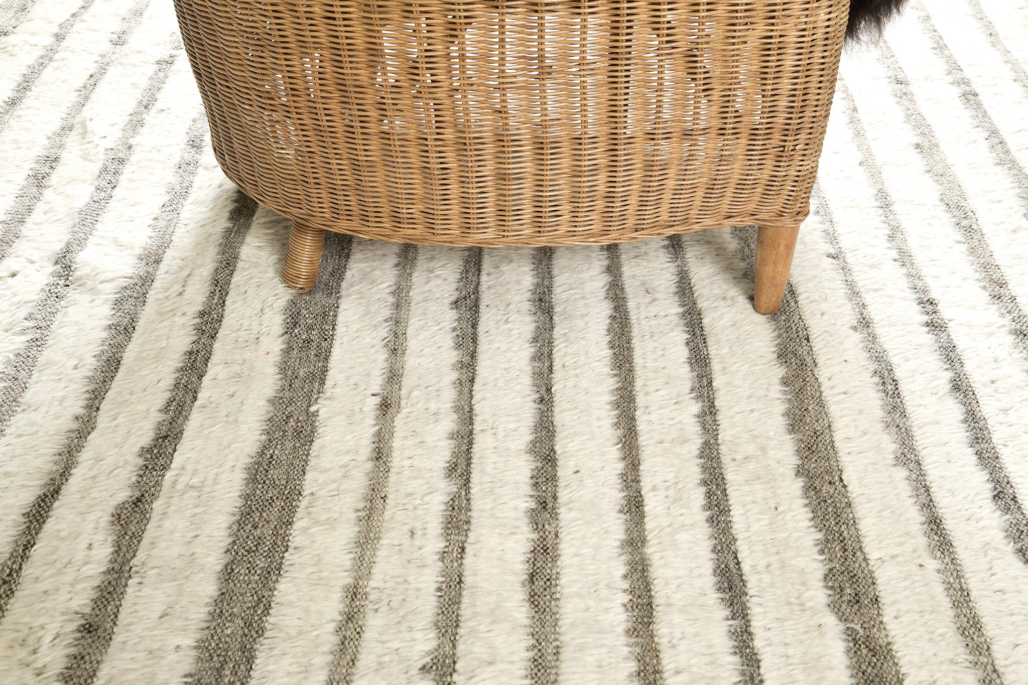 Shipca is a handwoven luxurious wool rug with timeless embossed detailing. In addition to its neutral-toned flatweave, Shipca has a beautiful gray shag that brings a lustrous and exciting feel to one's space. The Haute Bohemian collection is