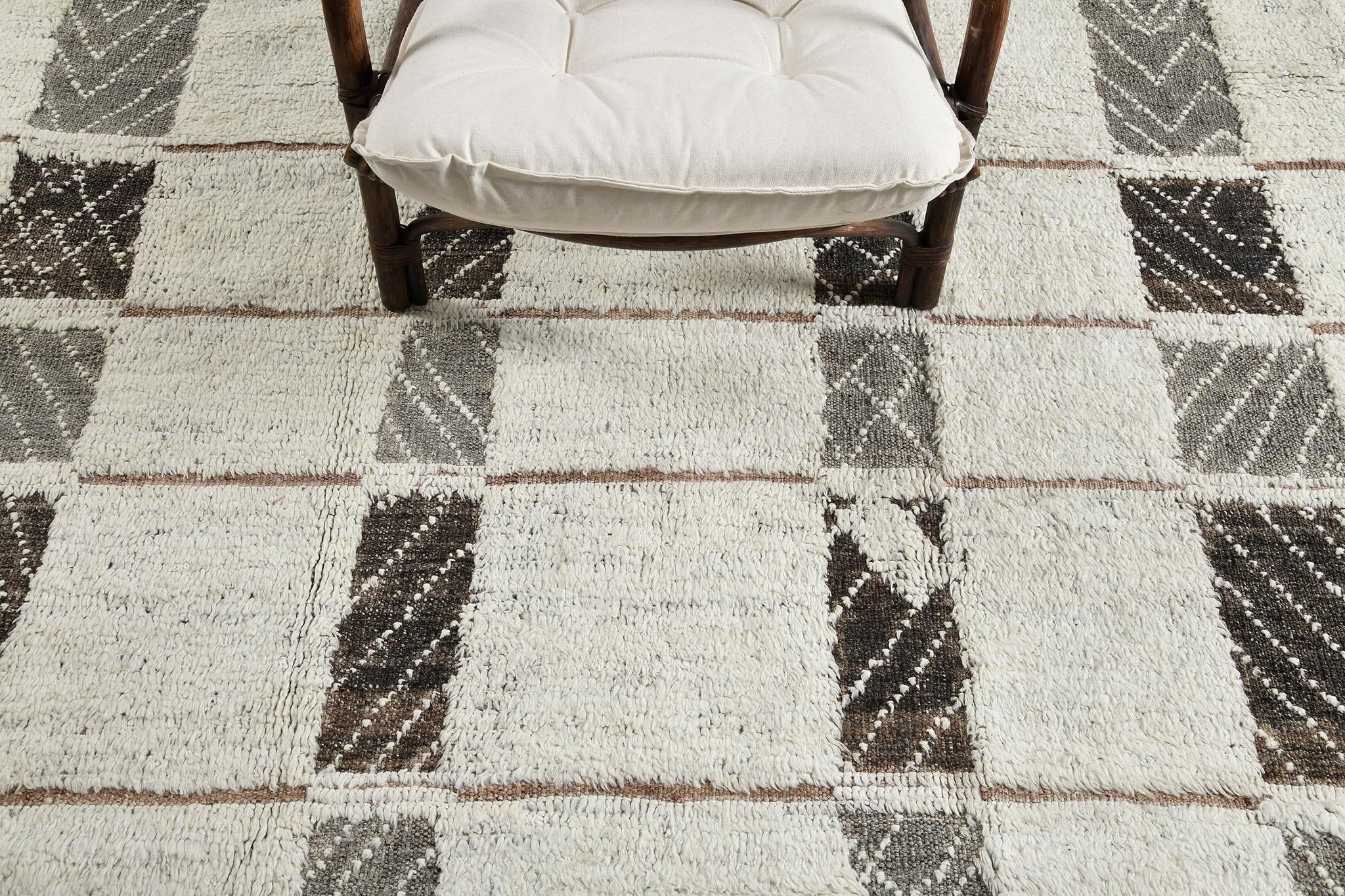 Tavsot’ in Nomad Collection features stunning optical lozenge backdrop overlaid with rectangular ivory patches. Its perfect neutral scheme of gray, mocha and ivory is well suited for minimalist interiors. Cozy and sophisticated, this mesmerizing rug