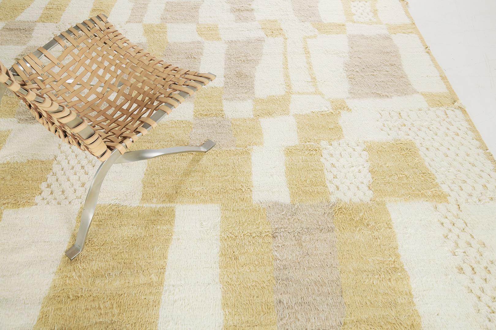 Tladtig’ features a series of irregular shapes forming together in a sophisticated neutral colour palette. Rendered in the soothing shade of ivory, oat and canary yellow, this mesmerizing rug is a work of art that will inspire awe to its every
