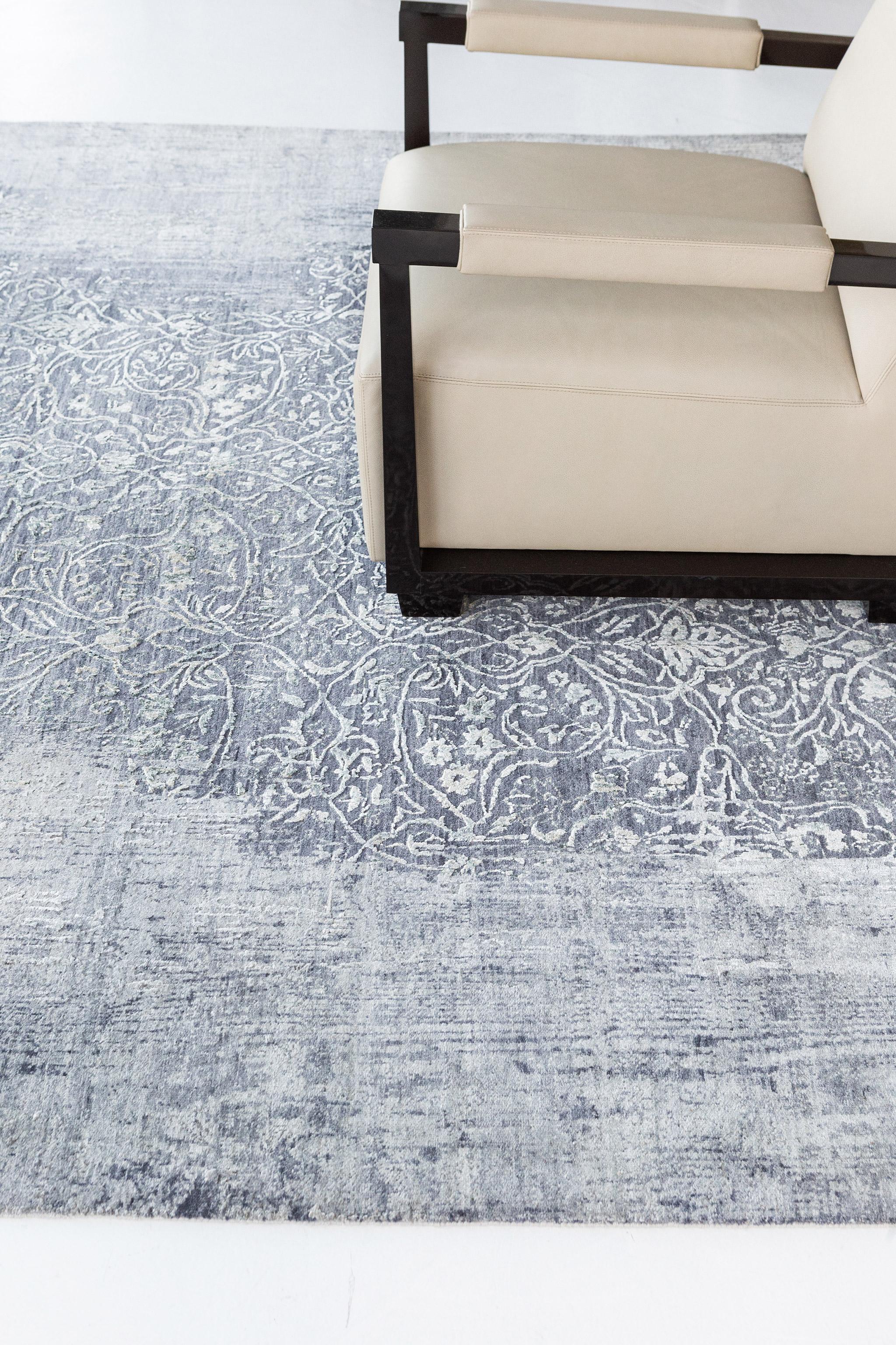 A sophisticated Transitional Design rug that is impeccably woven with various botanical elements in the soothing muted combinations of yale blue and cream accent. This refined rug charms with ease and beautifully embodies transitional dainty style.