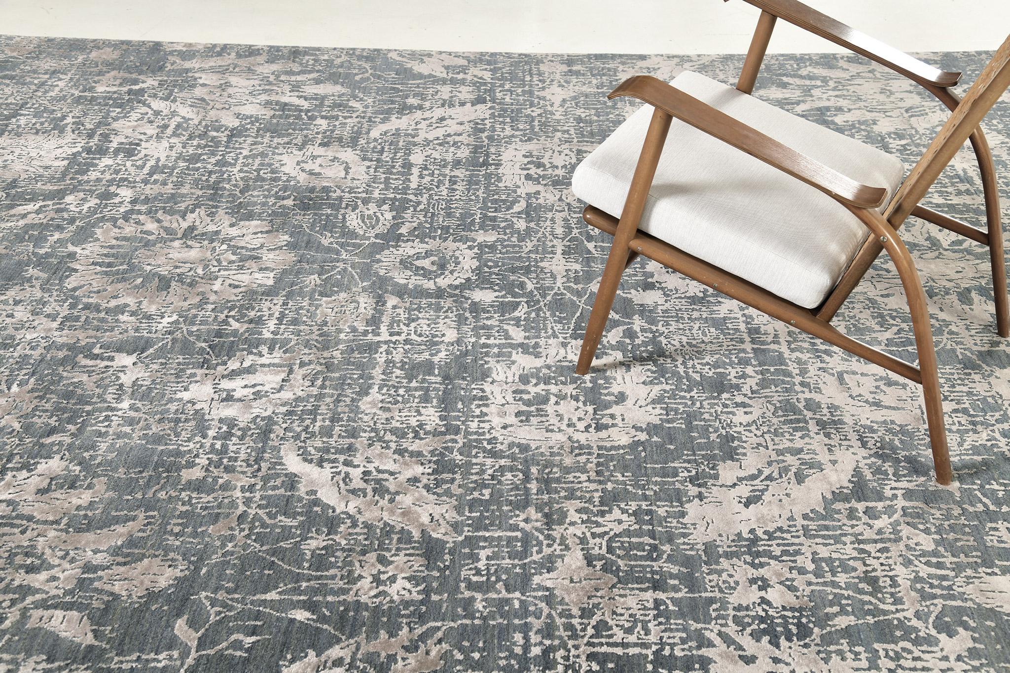 Mezzo is a wool and silk rug in transitional abstract of definitive flowers and vines over amazing tones of ash and pacific blue. A masterpiece that balances quality with contemporary and modern spaces. A timeless design that is surely a great hit