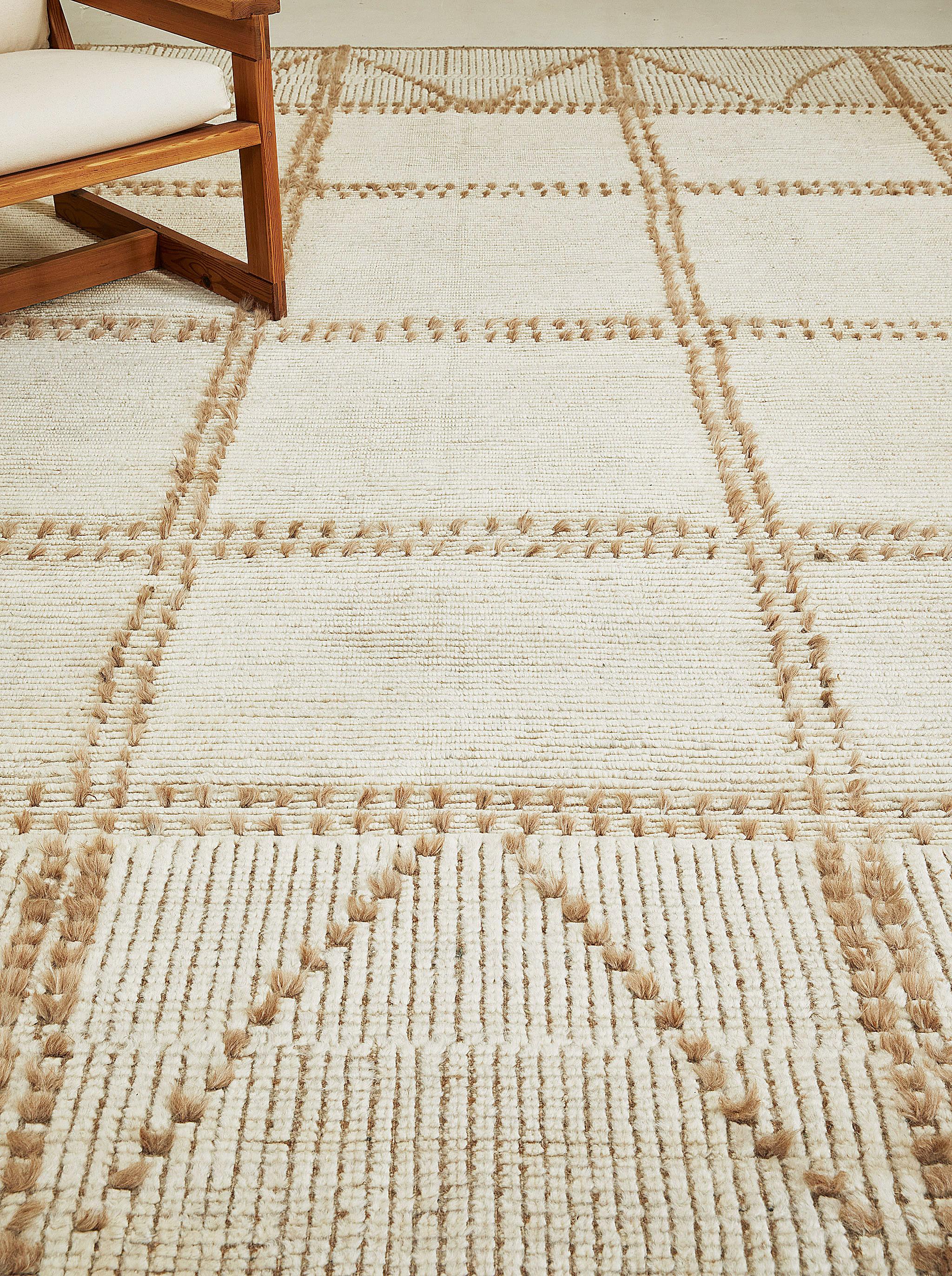Valdepena’s long knots contrast with trim ribbed pile creating a harmony of texture and color. A linear motif finished in diagonal zags at top and bottom.

Here in clay: warm taupes in the flatweave are echoed in the long knot accents.

The Estancia