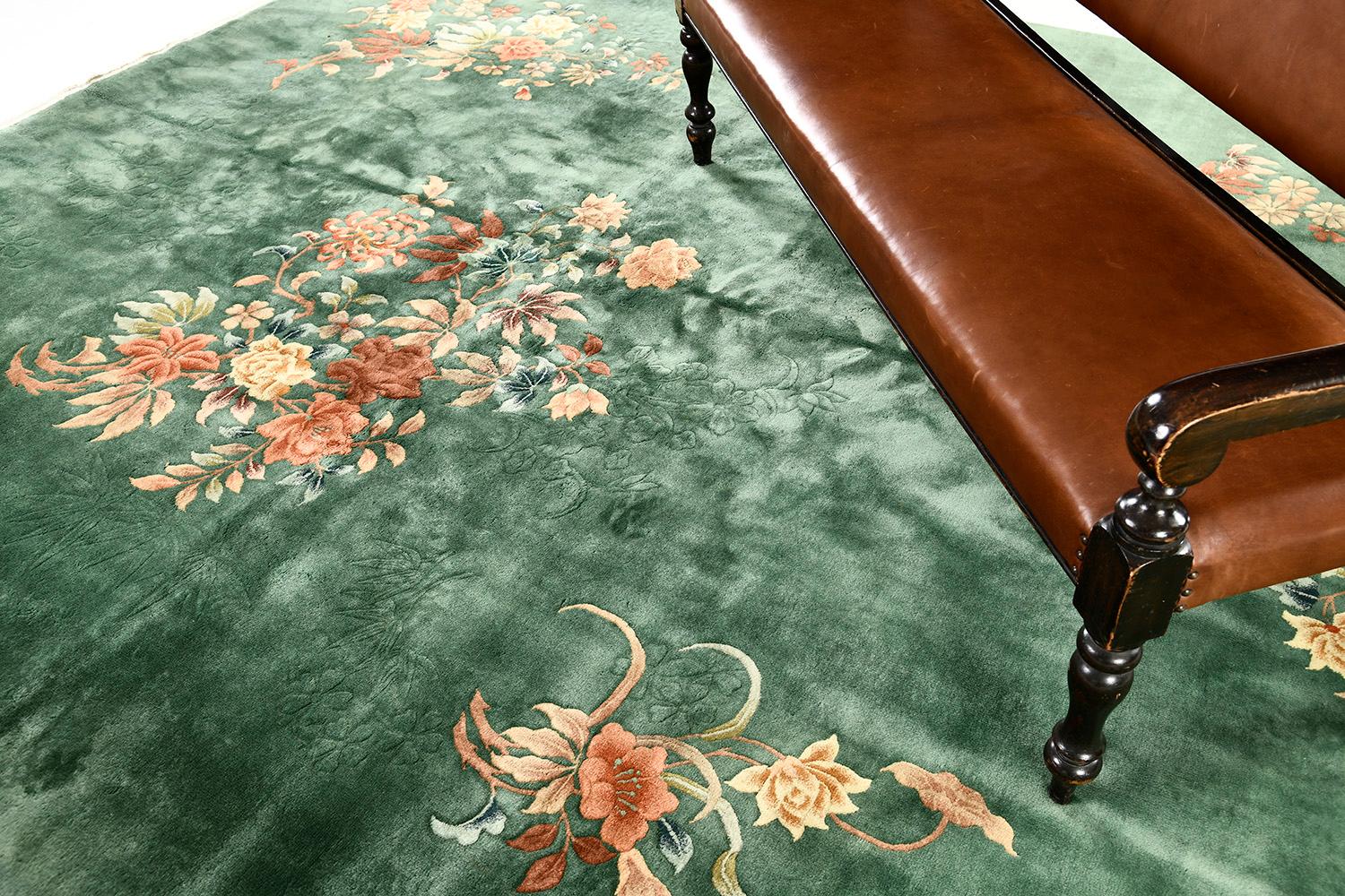 A vintage Chinese art deco rug that will leave lasting impressions and elevate any design space. A glorious nature field and blooming embellishments are added to the traditional floral vines work together to create a lively and stylish elegance.