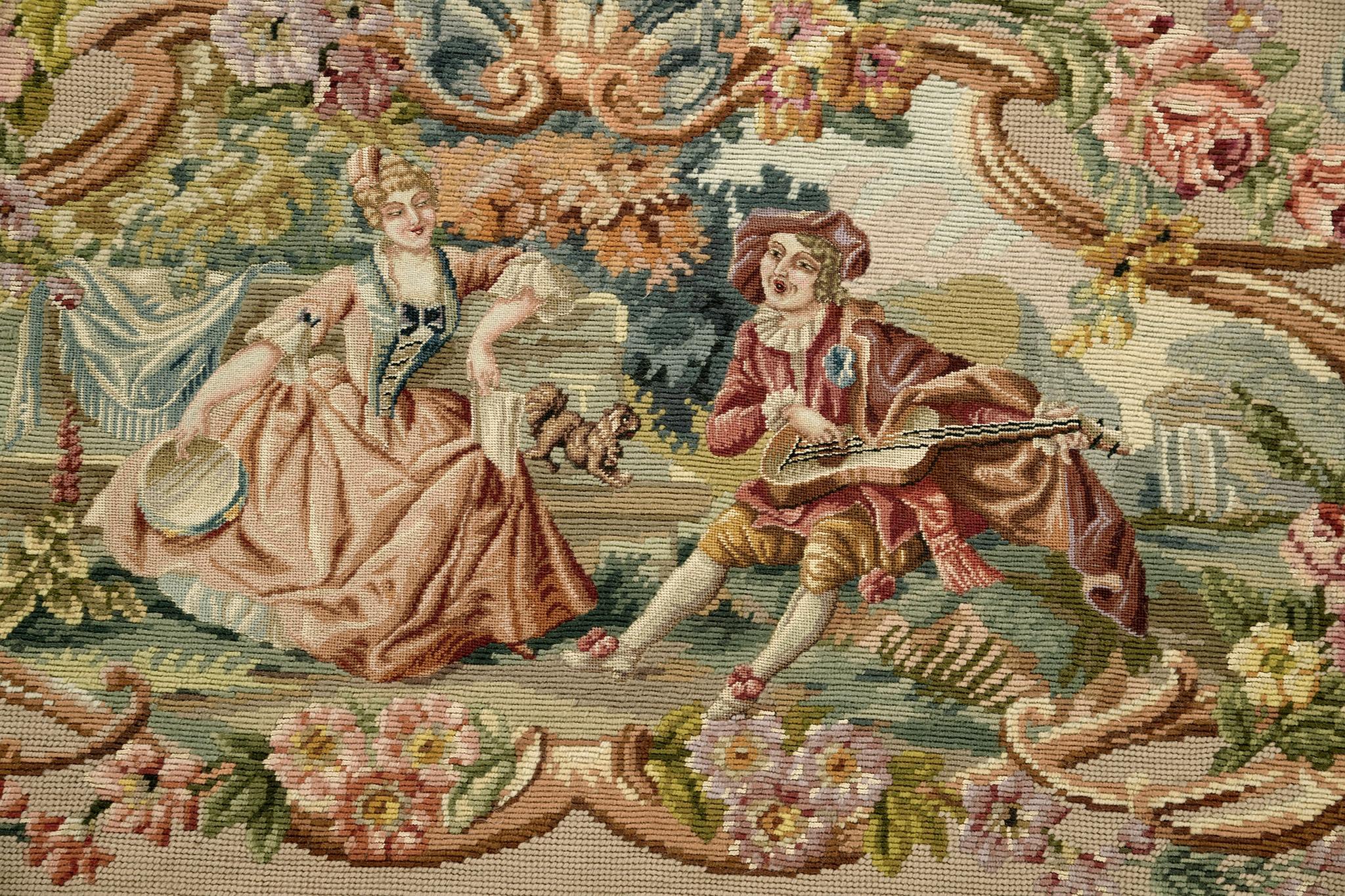 Meticulous flat weave wool and silk vintage French Needle Point rug depict a man and a woman enjoying each other's company in the middle of paradise. A magical and enchanting detail has been set for a masterpiece like this. A stylish wall piece or
