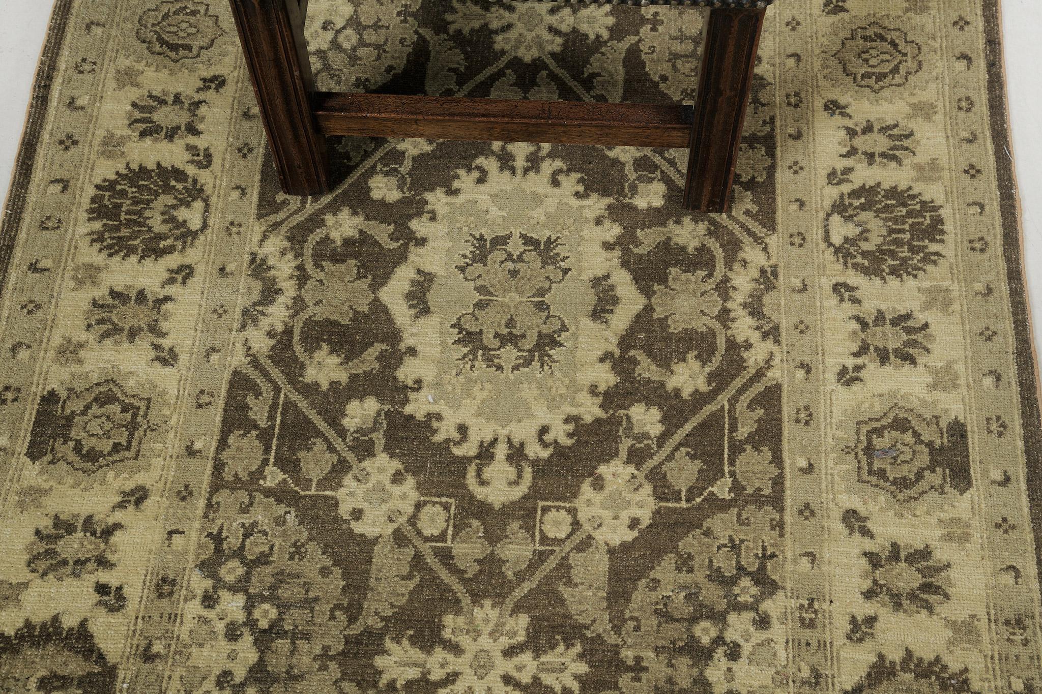 This majestic Mahal rug revival has created an outstanding pattern. It features well-coordinated neutral tones of mocha, black, and cream. This elegant rug is composed of enchanting peonies, lotus, and motifs forming a symmetrical pattern in the