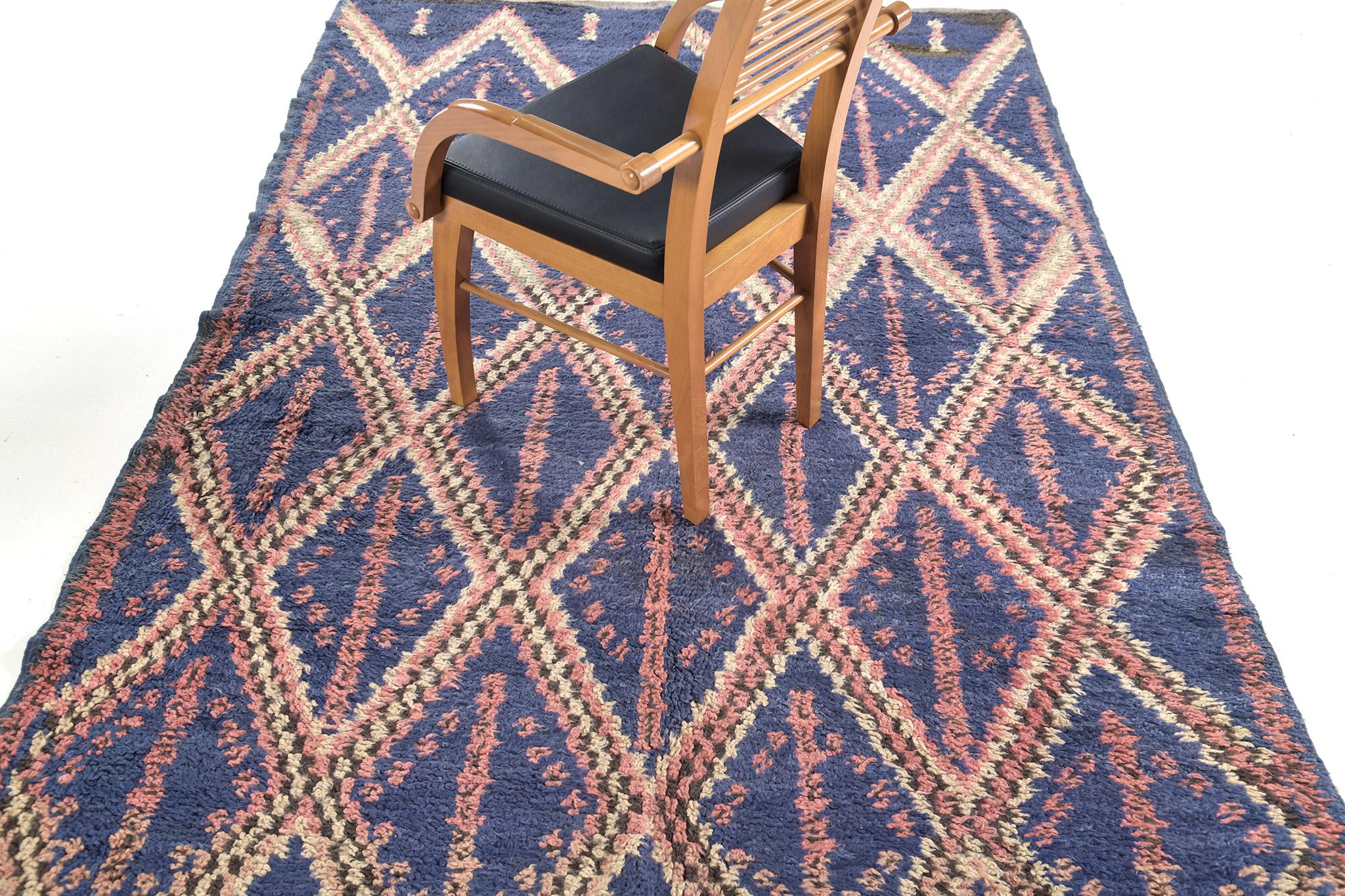 A breathtaking Vintage Moroccan Ourain Tribe rug. This magnificent rug features slate blue, hints of salmon and cream that create a gorgeous and exquisite piece that will enhance a wide variety of interiors. The panel design patterns of lozenge