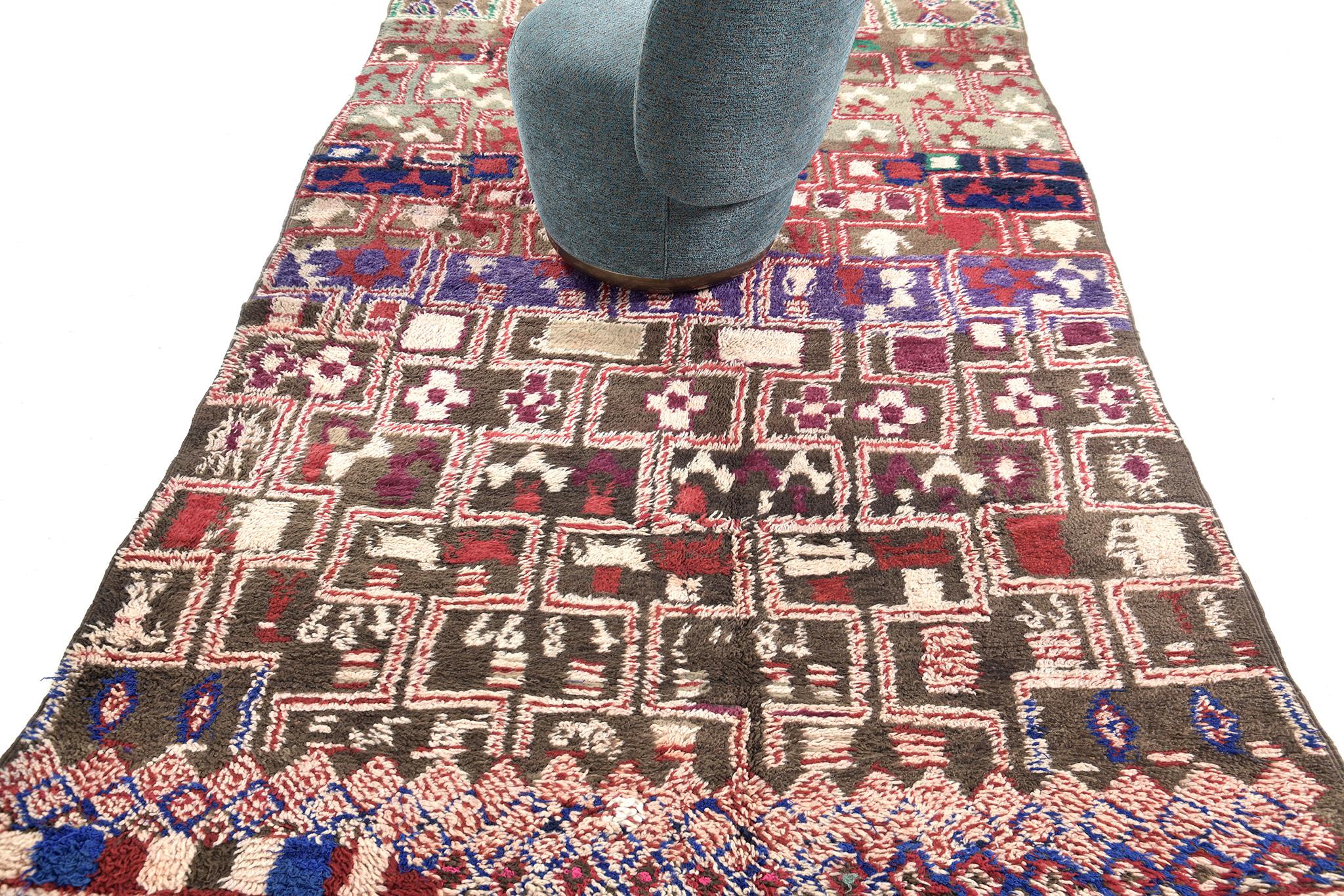 Be captivated by this mesmerizing rug that displays eclectic character through its festive selections of colour scheme. This breathtaking rug features various and ambiguous Berber patterns. Sink your feet into this Vintage Moroccan Ourain rug that