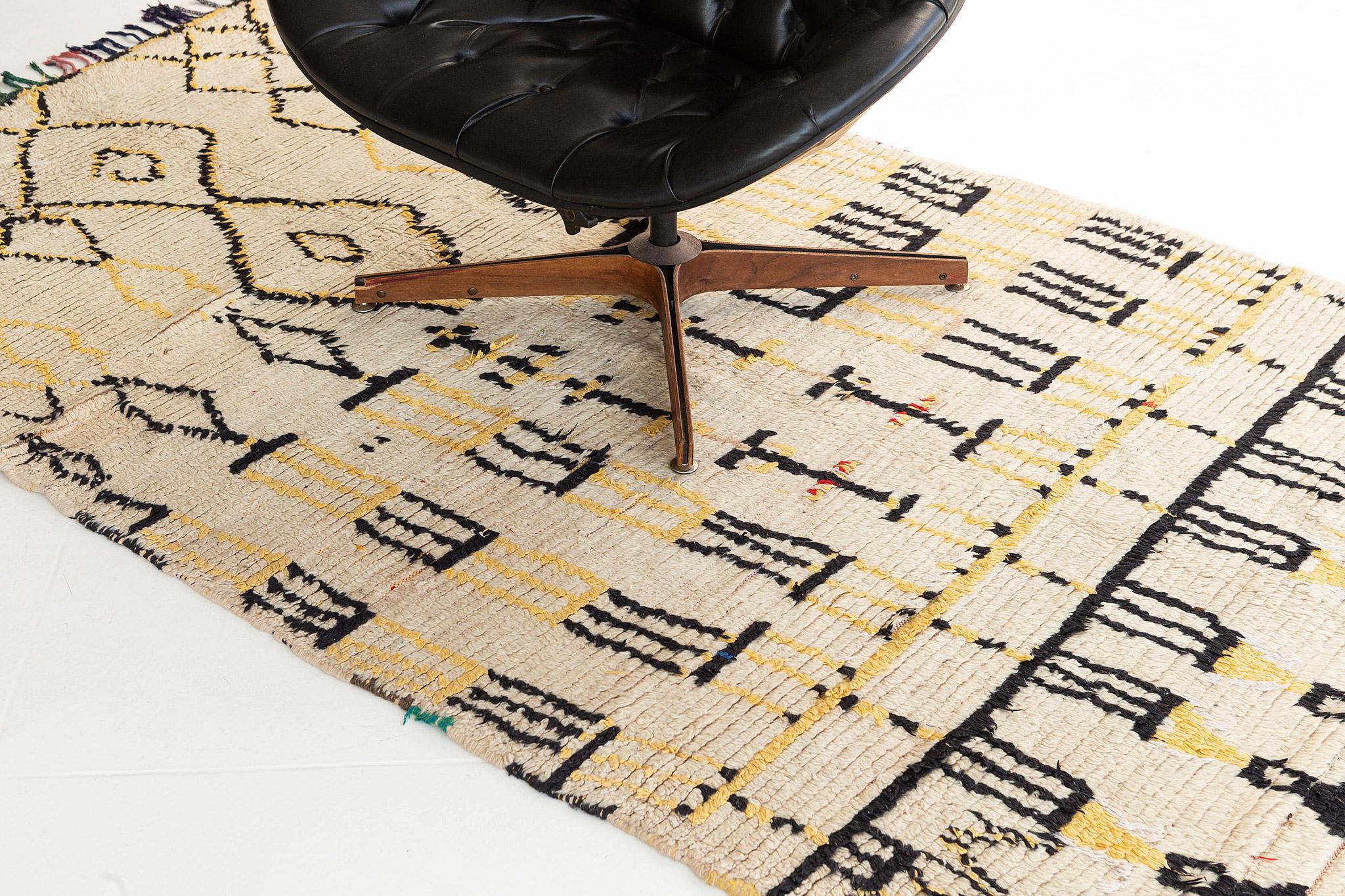 With its primitive charm and enticing asymmetry, this Vintage Moroccan Azilal Tribe rug features a visually impeccable design. This exceptional rug displays a stunningly symbolical patterns woven in the warm tones of ivory, charcoal and yellow.
