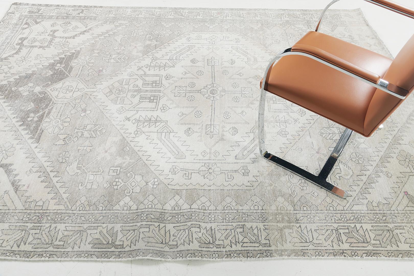 Revealing the magnificent art form, this mesmerizing rug will definitely fascinate you upon laying your eyes on this Vintage Persian Bakhtiari Rug. Rendered in the soothing neutral tones, this rug creates breathtaking geometrical patterns that
