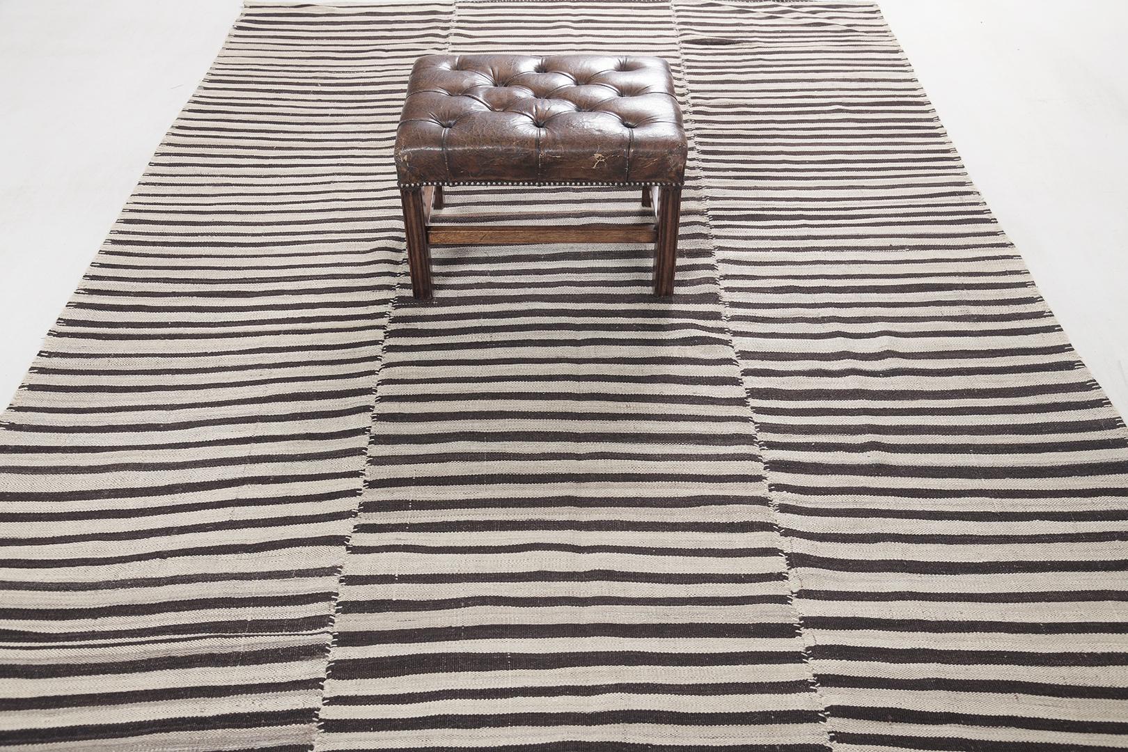 This Persian Jejim Kilim is a banded flat weave with alternating hues of cream, khaki, and clay brown in multi-column stripes. Persian flatweaves are made up of some of the best wool and weaved exceptionally to create interesting textures. This