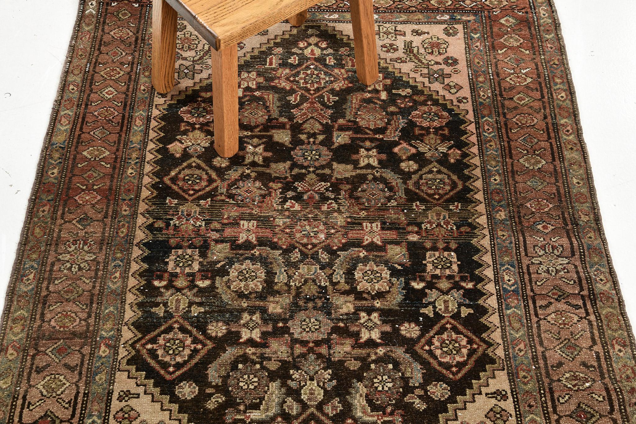 A stylishly impressive hand-spun wool Persian Malayer Rug has immensely flexed its series of the band along the perimeter of gigantic ebony hexagon features. It is surrounded by different kinds of blooming rosettes and geometrical motifs in