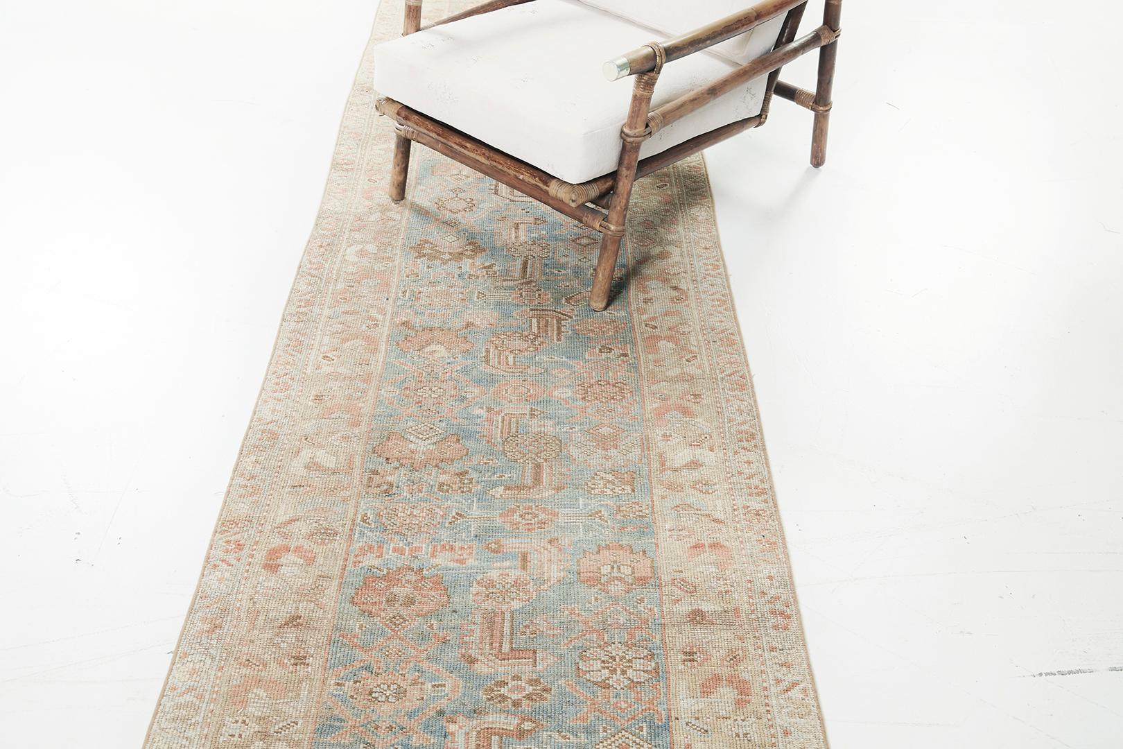 This elegant and timeless Vintage Persian Malayer runner has an intricate botanical motif that has clear dainty florid elements all over the design. A fusion of warm and cool color palette perfectly highlights the rug’s distinct sophistication. A