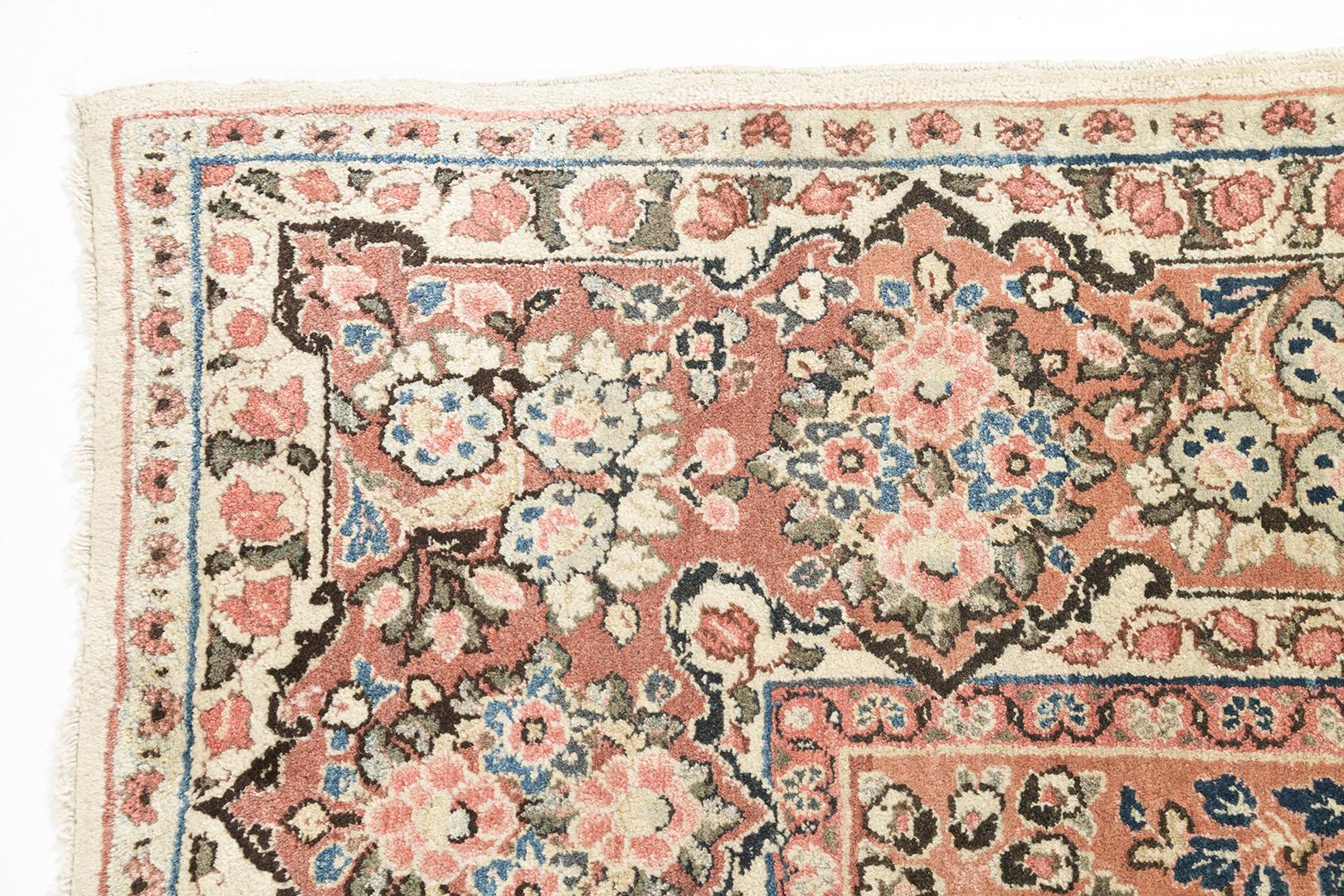This gorgeous Sarouk rug with a multi-colored pattern that brings out the beauty of the design. It has a field of cream base color and a neutral and sage blue design of a medallion. The medallion in its core is well-complemented with the borders and