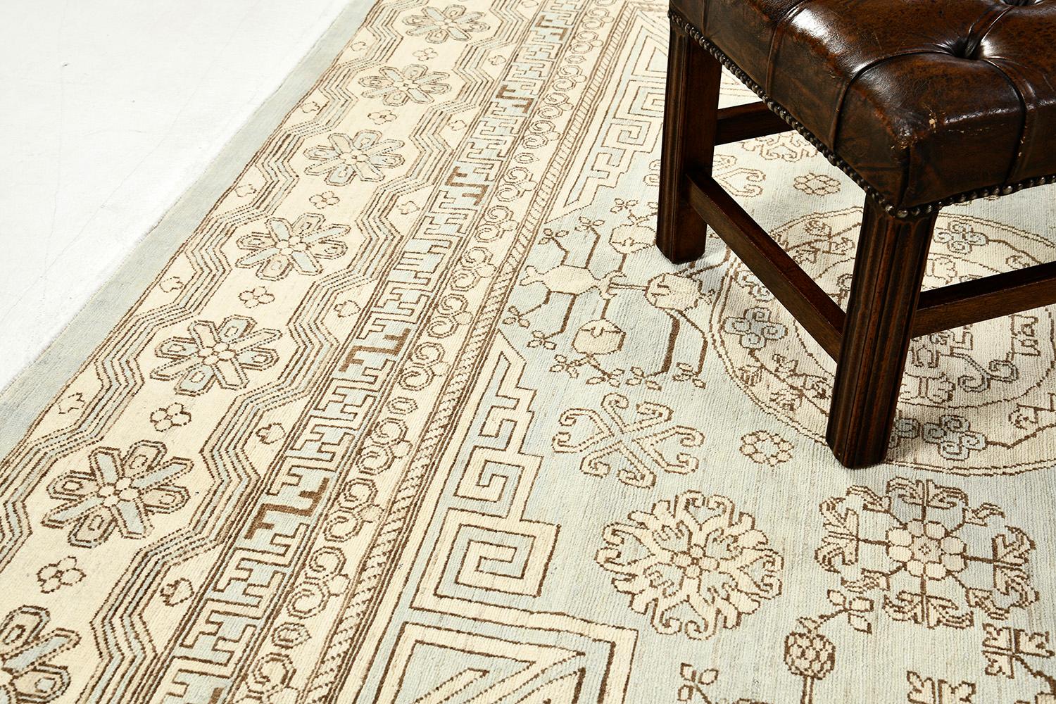 An impressive pile woven wool Khotan design re-creation from our collection has come and flexed its versatility.  Three grandiose medallions and connecting motifs in sands and sky fields dominate the entire pattern of the rug. Beautiful floral bands