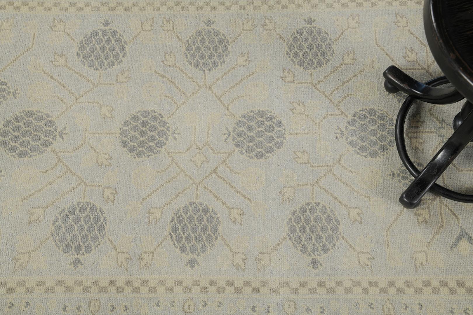 Khotan design rug in vintage style features symmetrical sets of pomegranate elements with geometric vines. Subtle colors blended in muted blue and gray. Surrounded by checkered borderline, symbolic motifs and elements are added to have a great