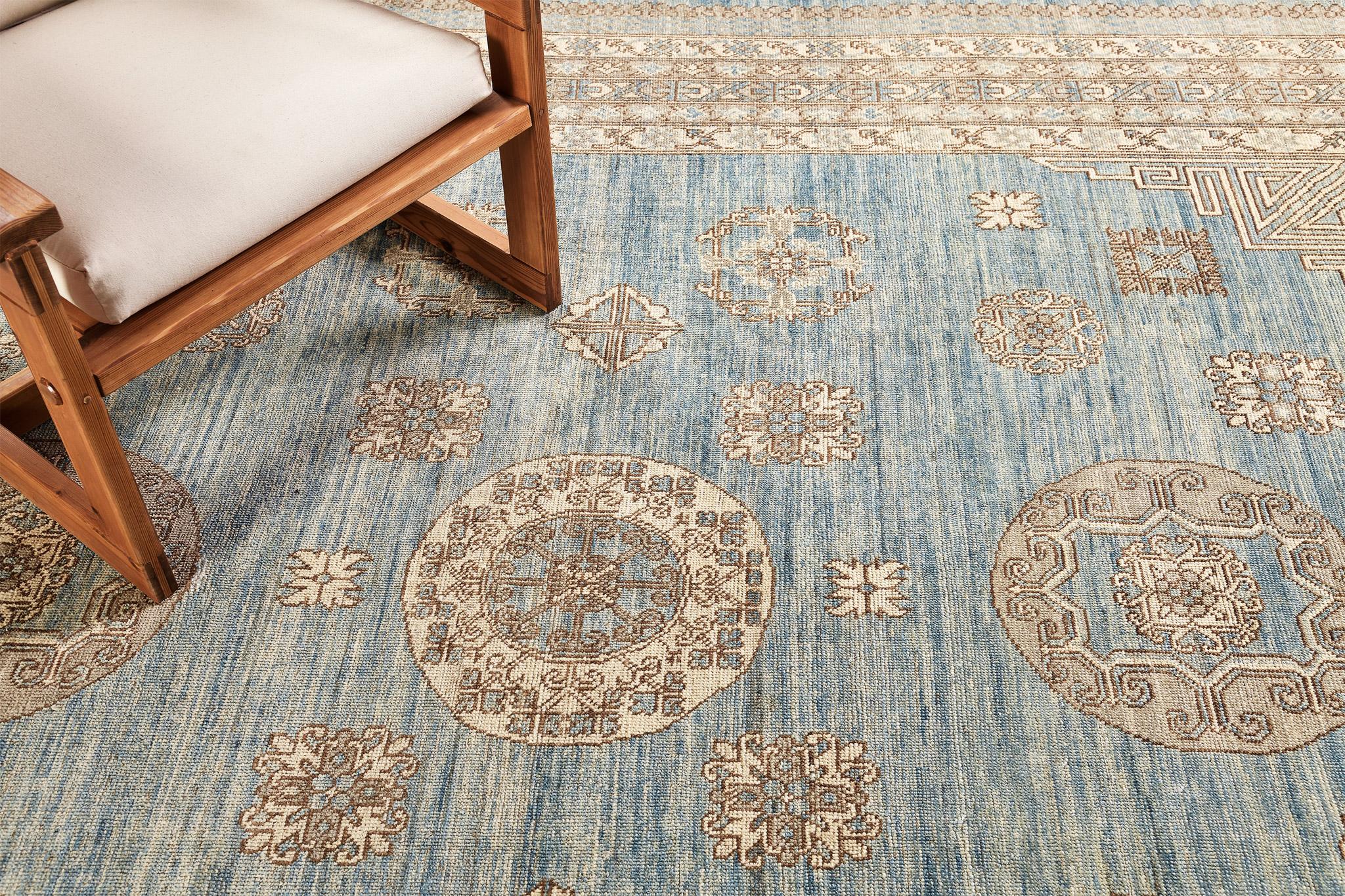 A majestic revival Khotan rug that establishes a unique character by the intricately incorporated elements and unique colour combinations. The tranquil effect by the abrashed cerulean field makes the medallion accents stand out in a magnificent way.