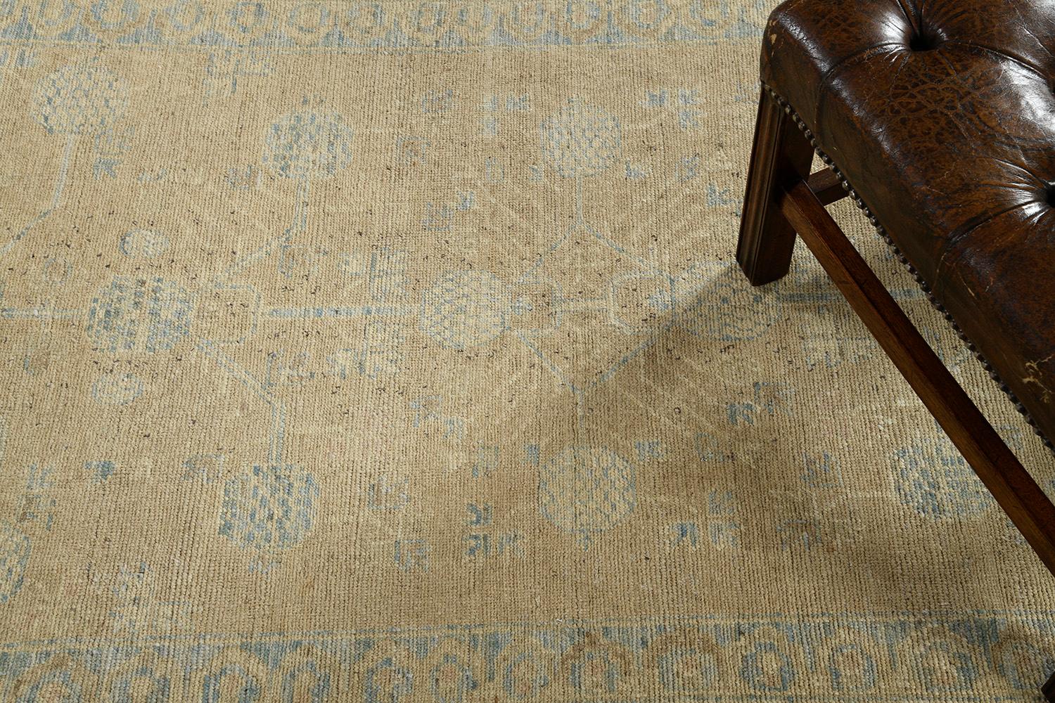 A gorgeous Khotan design runner that showcases a symmetrical pomegranate pattern connected by a network of florid elements enclosed by four floral meander guard bands. This magnificent rug exudes cozy and casual elegance with an idyllic coastal vibe
