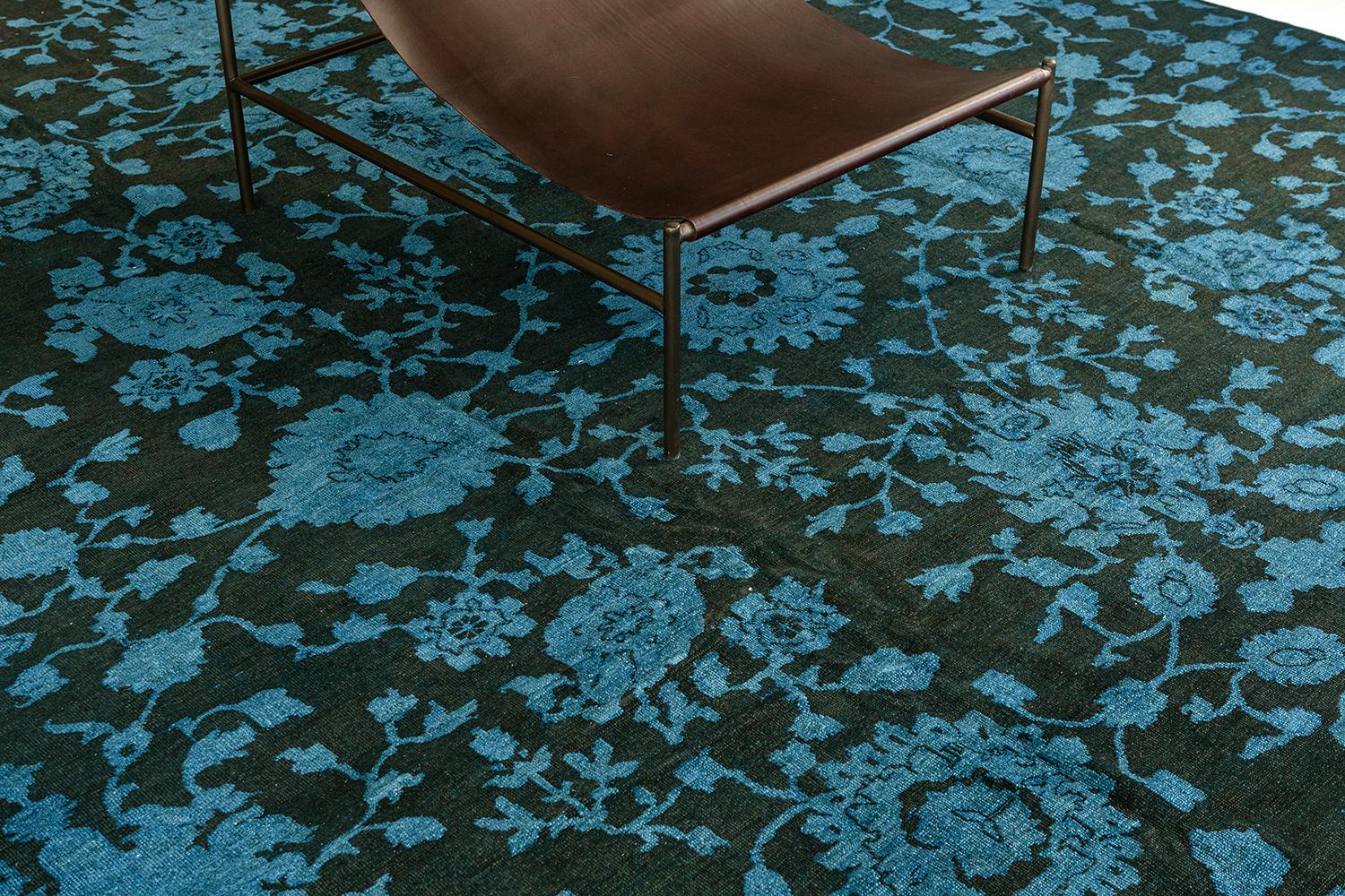 With an impressive all-over botanical pattern and striking appeal, this Transitional Design overdyed rug can beautifully blend contemporary, modern, and traditional interiors. It features the lush blooming palmettes with meandering vines gracefully