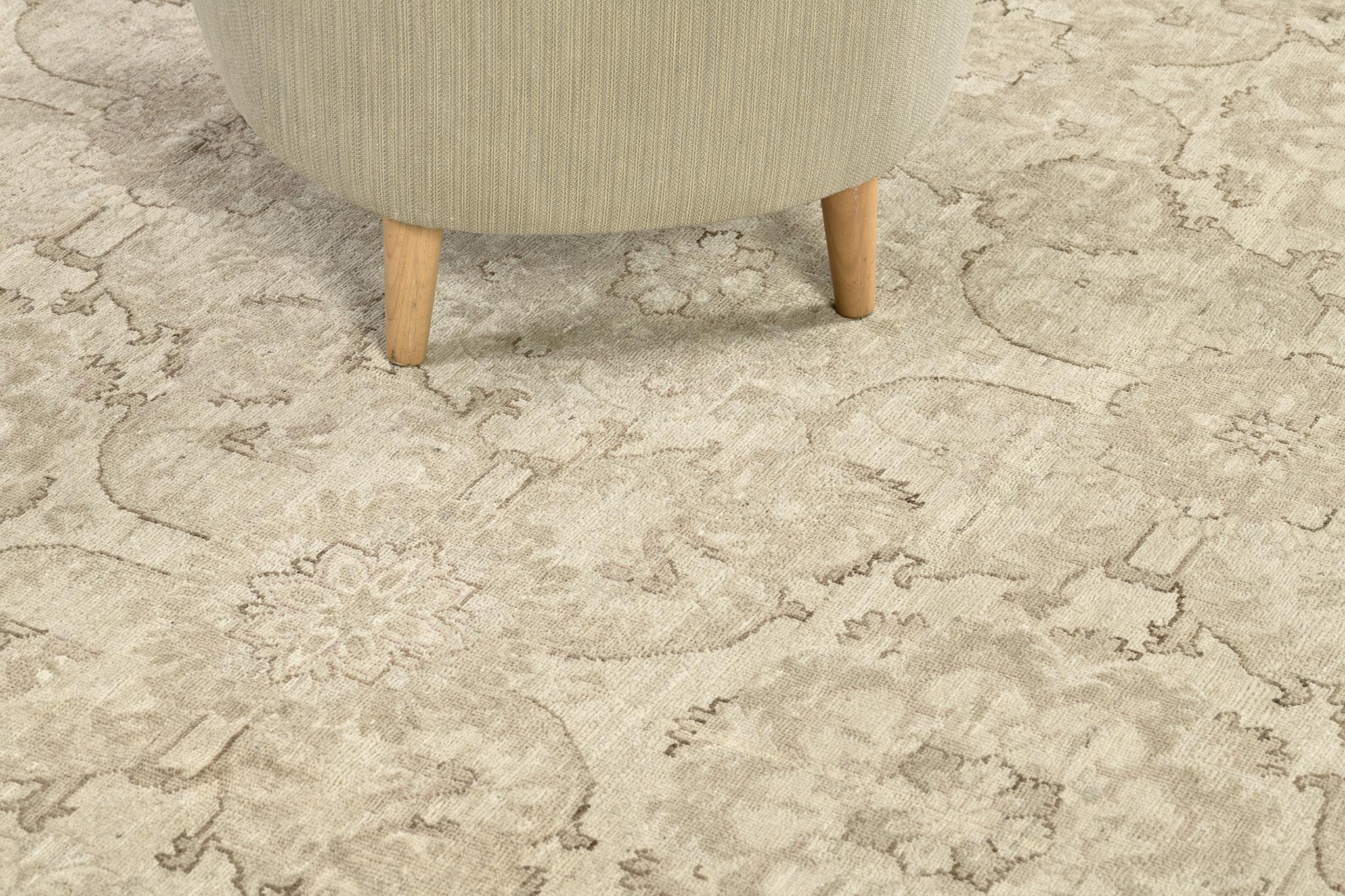 A brilliant array of floral forms, leafy tendrils and lush palmettes, this elegant Sultanabad revival rug was influenced by different traditions and cultures. Through the use of muted neutral color scheme ivory and taupe and establishing points of
