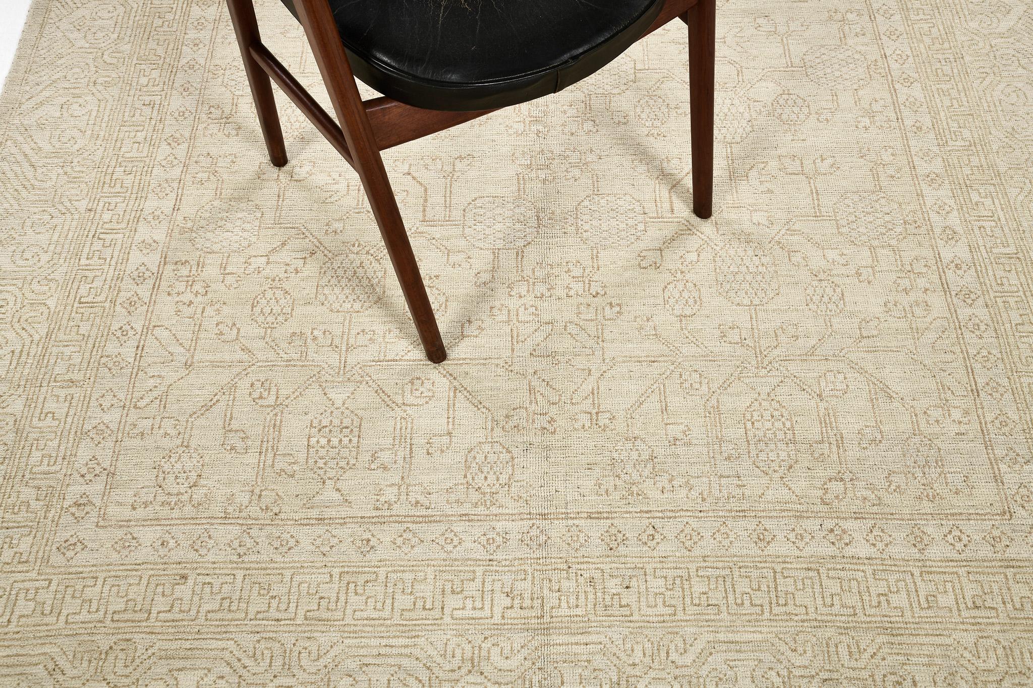 This contemporary Khotan muted revival rug has blending elements from the modern world with light and airy tones. From the pomegranate motif that is complemented with graceful branches and florettes densely fills the artistic composition. This