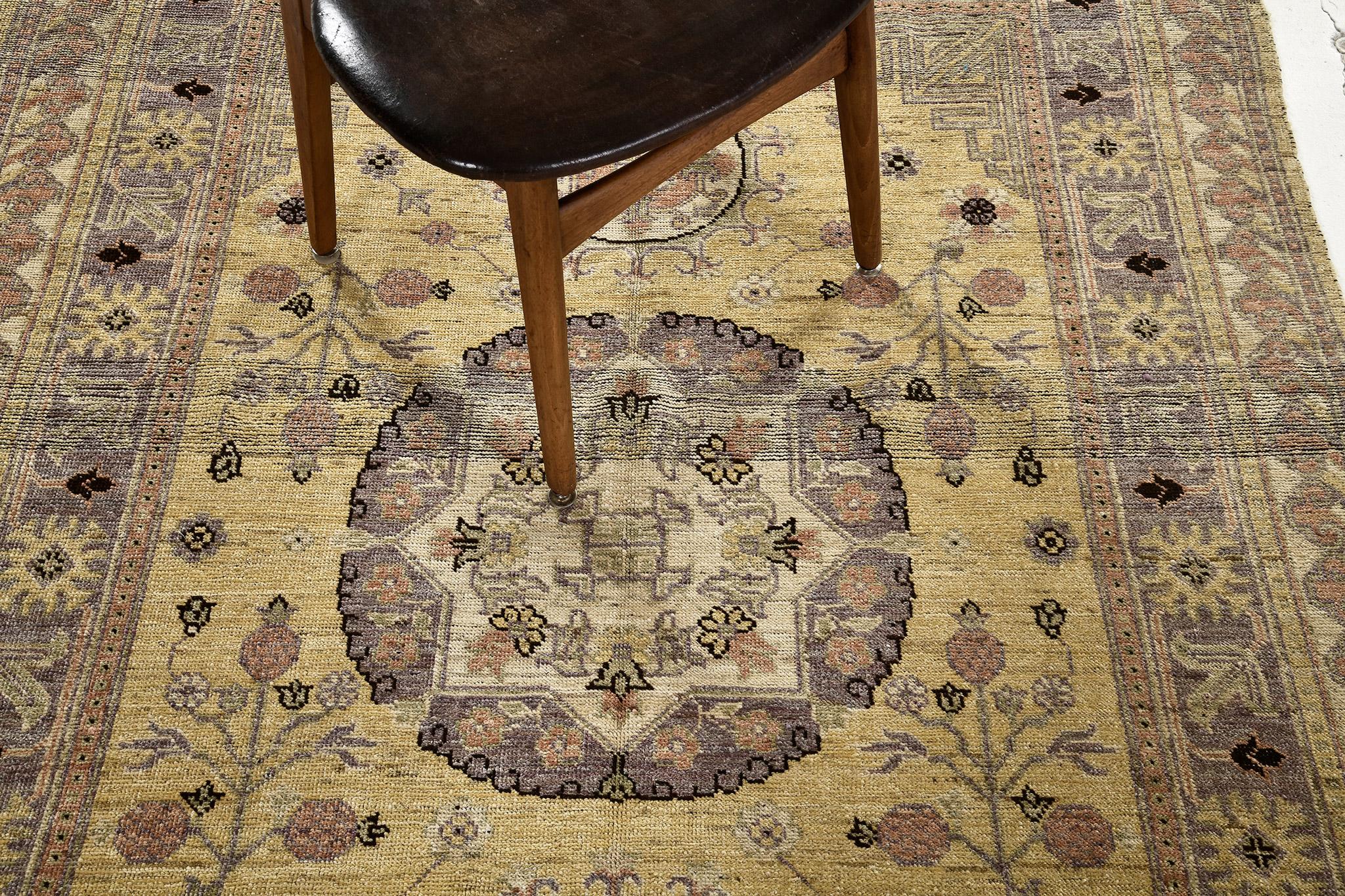 A sophisticated and chic collaboration of traditional and modern design Khotan revival rug that features a central medallion of florid garden elements surrounded by all-over sophisticated flower buds. Series of fascinating ornate borders encloses
