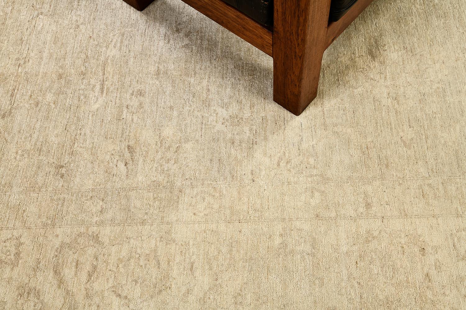 Amazing muted revival of Sultanabad rug that exudes formal elegance featuring a subtle touch of awe-inspiring floral composition. Blooming palmettes and serrated leaves are gracefully spread along the camel field. A breathtaking piece that will