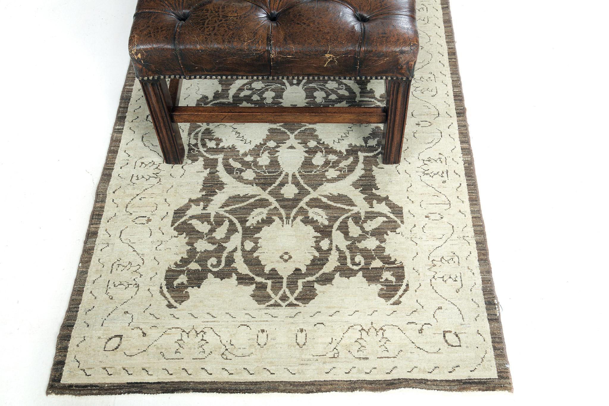 This impressive Tabriz runner centers an umber brownfield that reflects the symmetrical pattern of leaves. The main border contains symbolic motifs with an all-over lattice of scrolling vinery issuing split leaves and delicate flowering vinery that
